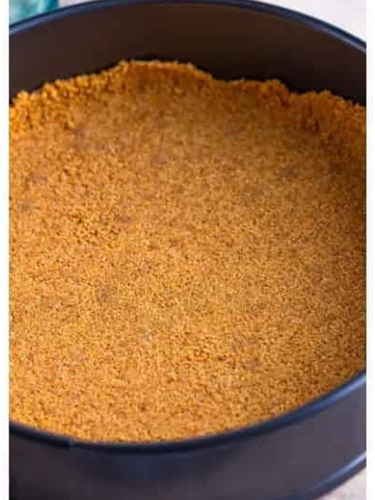 Graham cracker crust pressed into the bottom of a springform pan.