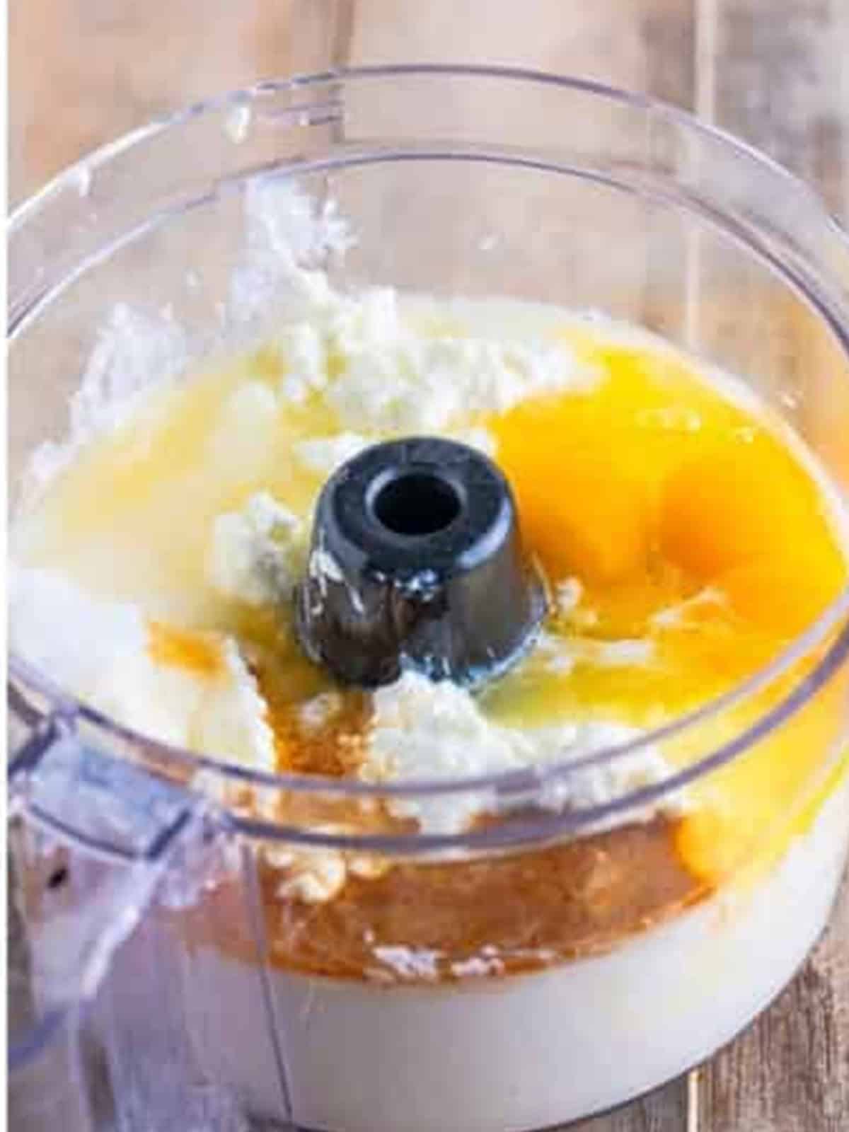 Cottage cheese, eggs, sugar, lemon, and vanilla added to a food processor.
