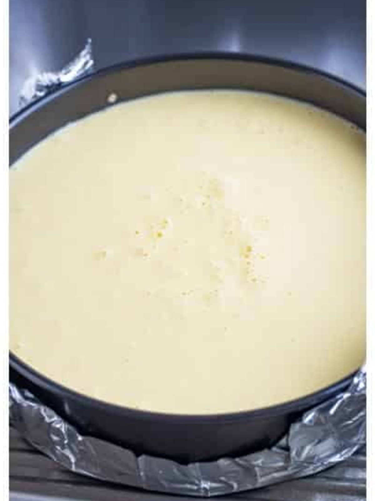 Cottage cheese cake filling poured into the foil wrapped springform pan.