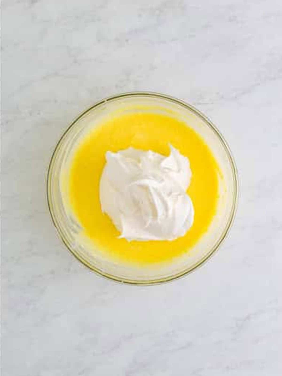 Folding whipped topping into the coconut pudding.