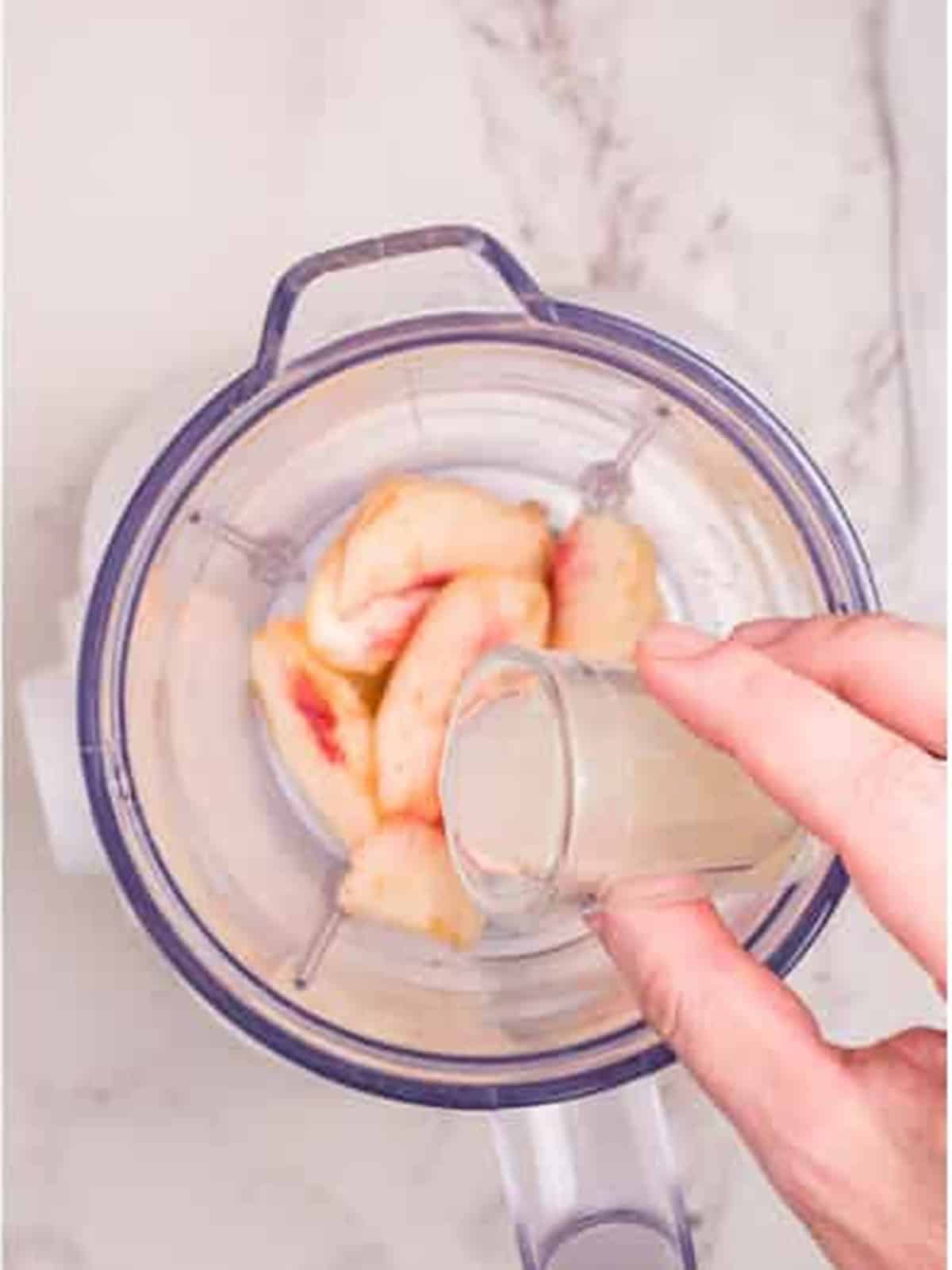 Adding lemon juice to the blender.