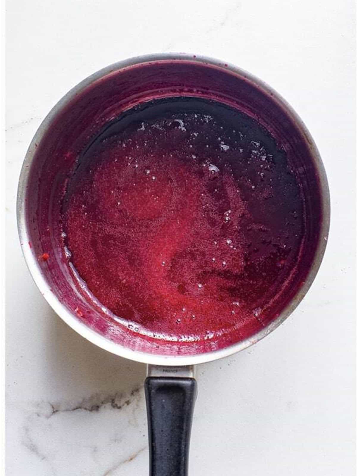 Smooth, thick finished Blackberry Sauce in a saucepan.