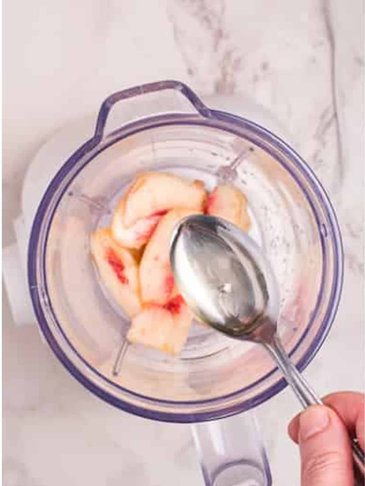 Adding simple syrup to the blender.