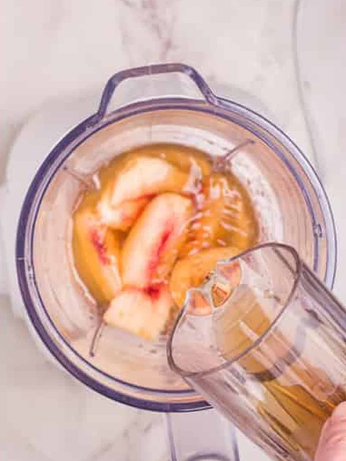 Adding brewed black tea to the blender.