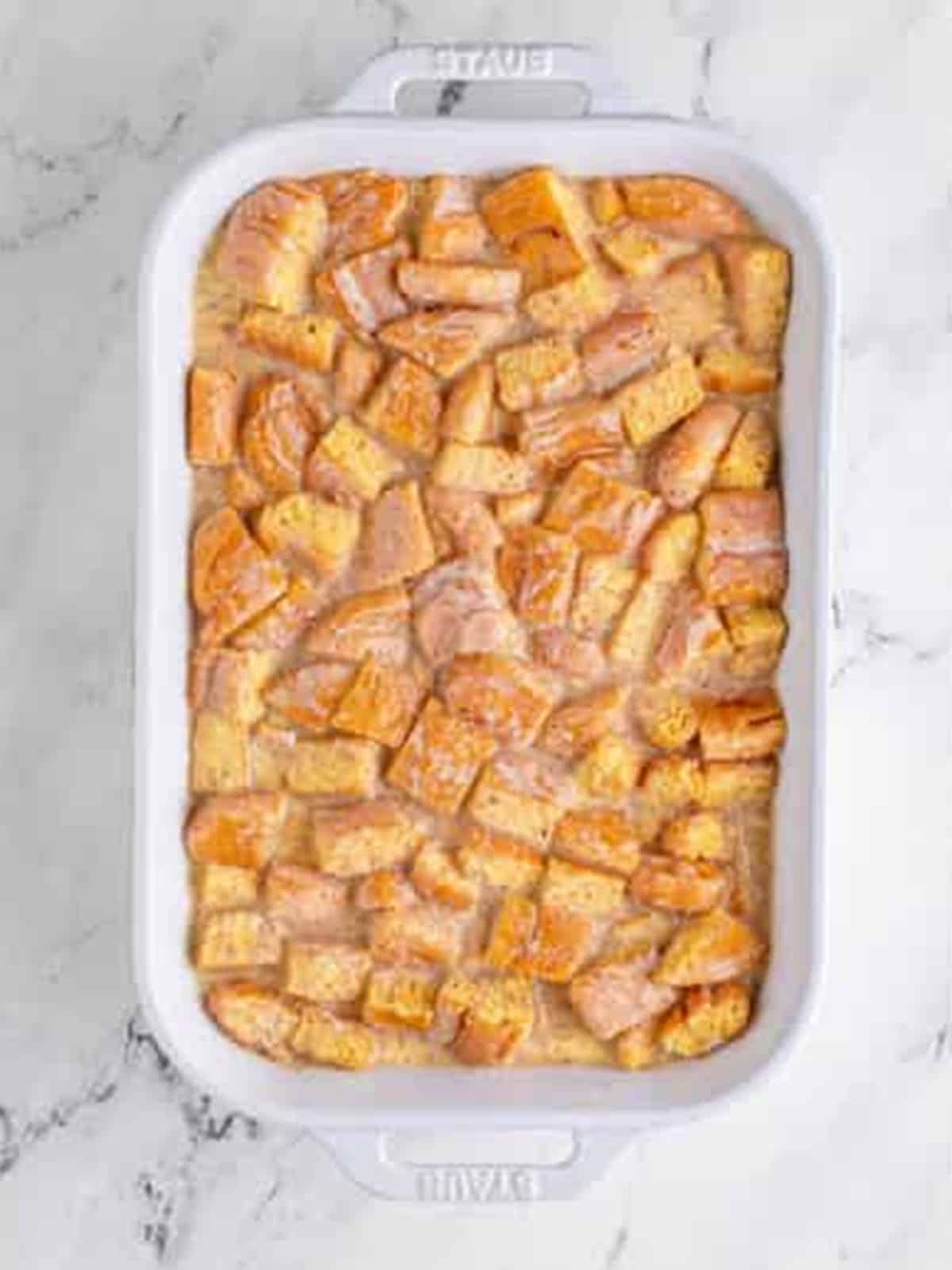 Pouring the custard over the honey buns.