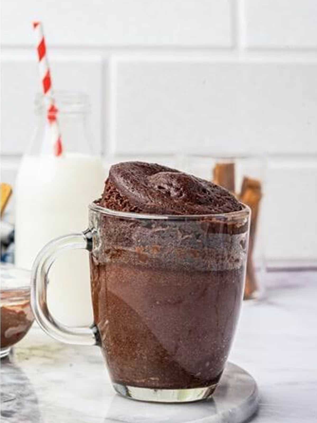Finished Nutella Mug Cake risen in a glass mug.