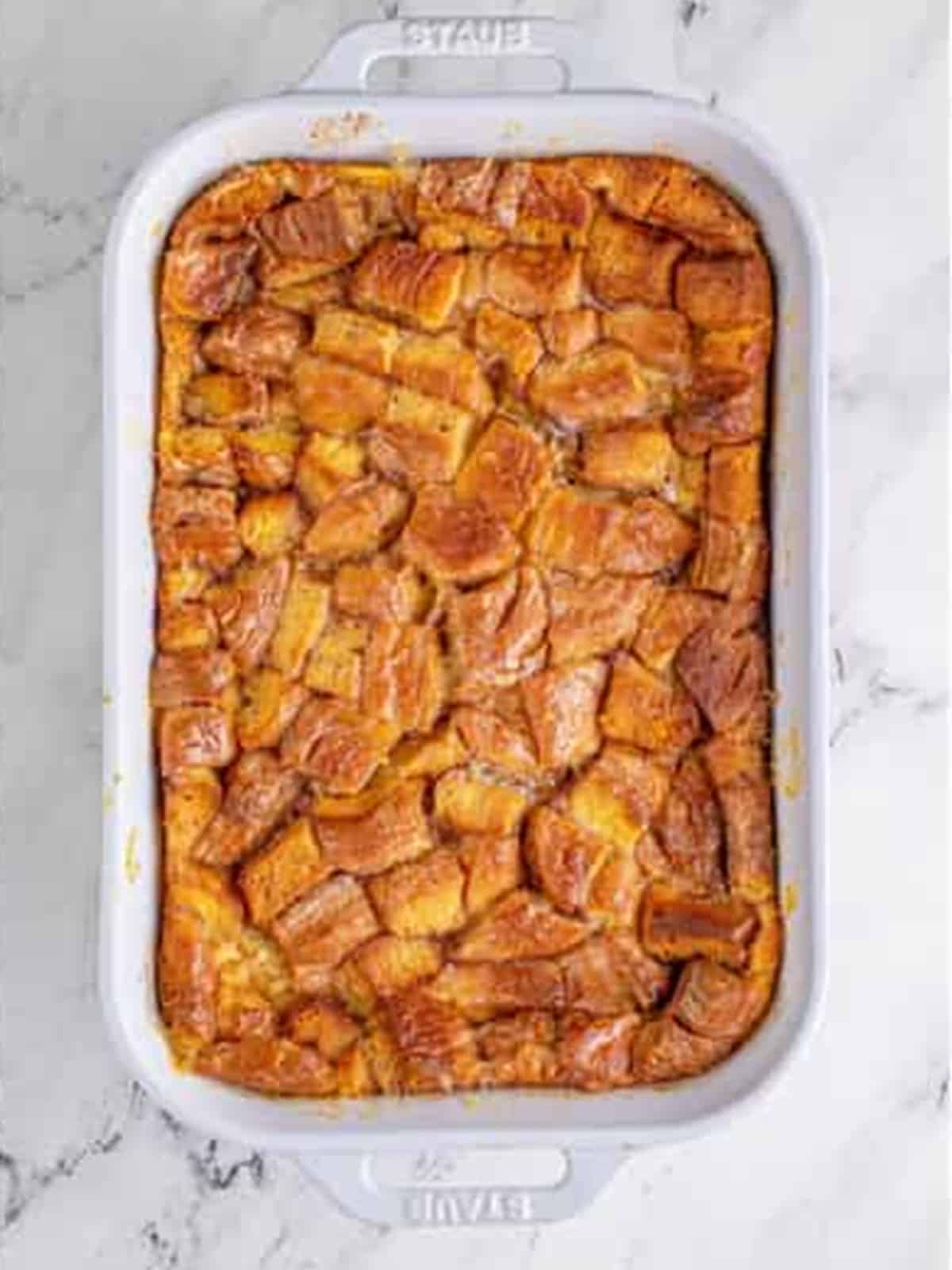 Baked Honey Bun Bread Pudding browned and puffed in the dish.