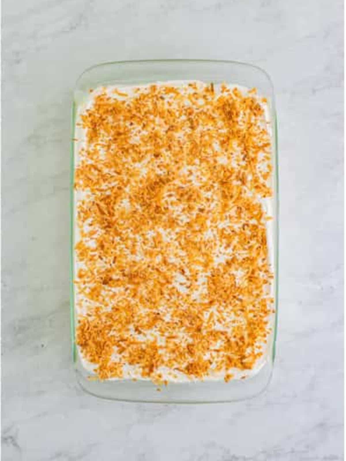 Finished Coconut Icebox Cake topped with toasted coconut.