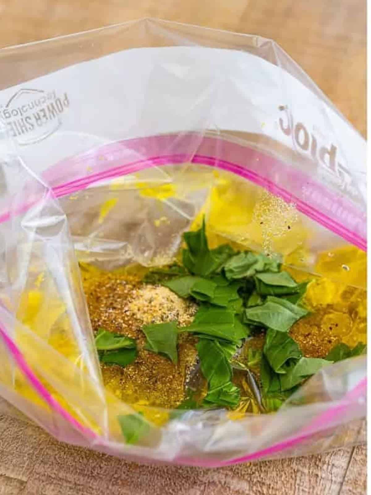 Olive oil, lemon, Italian dressing mix, and basil in a zip-top bag to make the marinade.