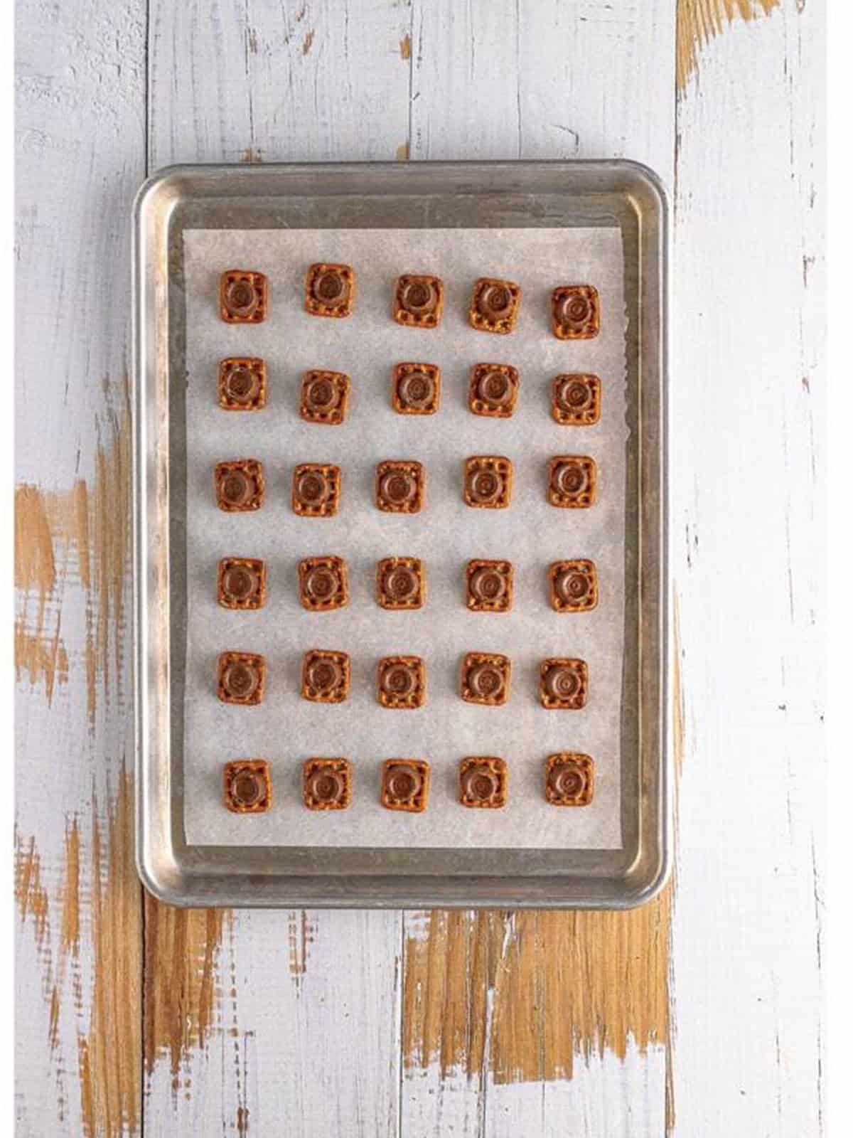 A Rolo candy placed on the center of each pretzel.
