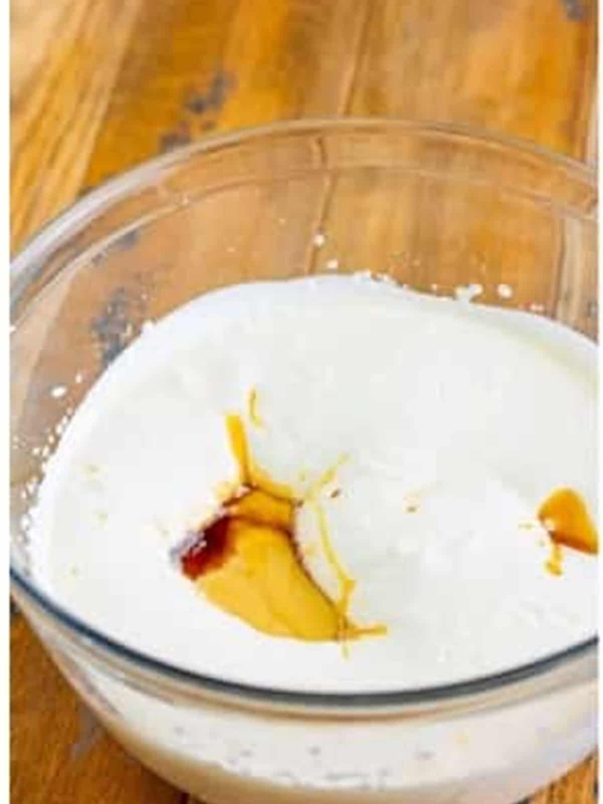 Adding sweetened condensed milk, butterscotch syrup, and vanilla to the whipped cream.