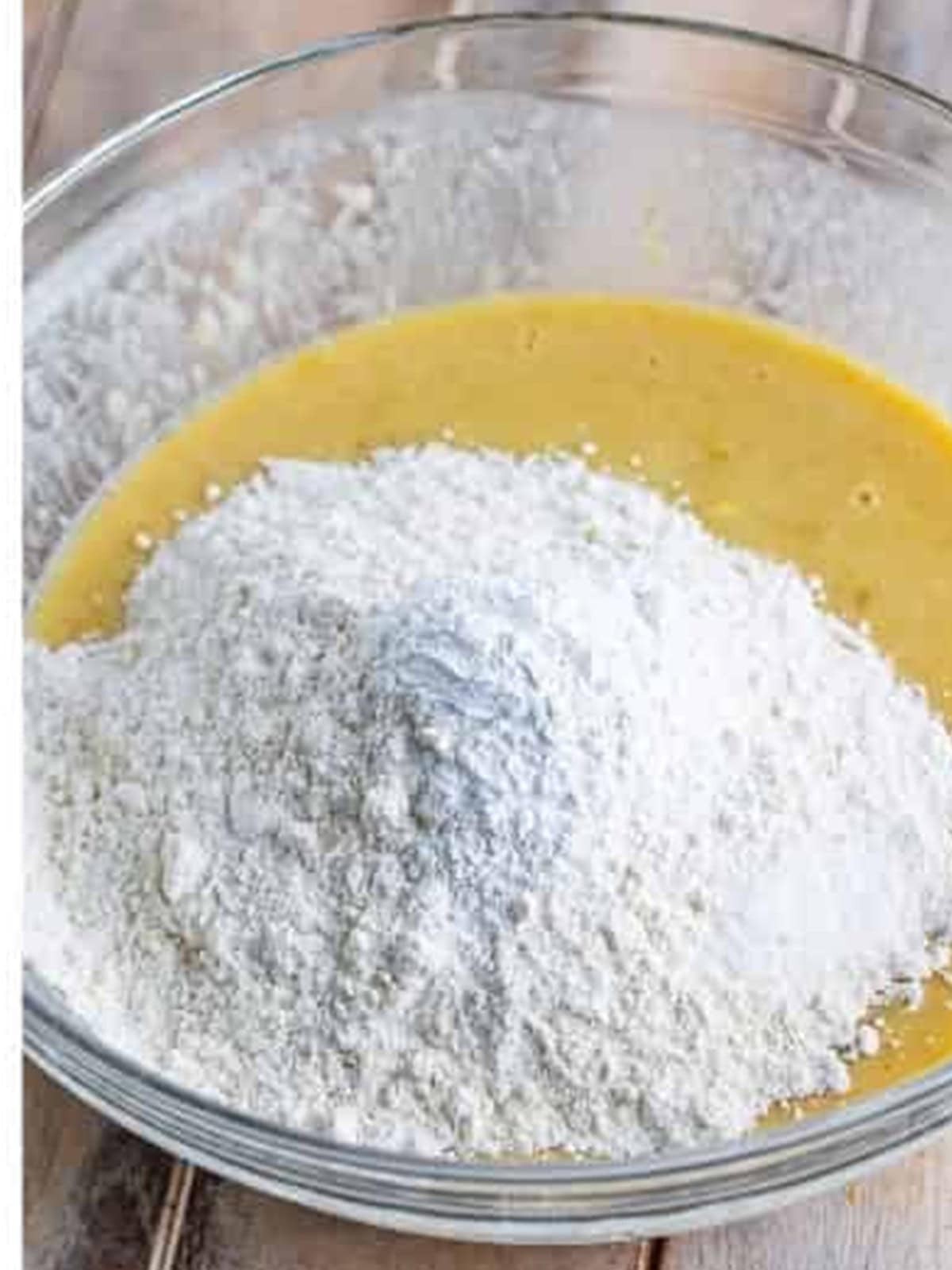 Adding flour, baking powder, and salt to the banana batter.