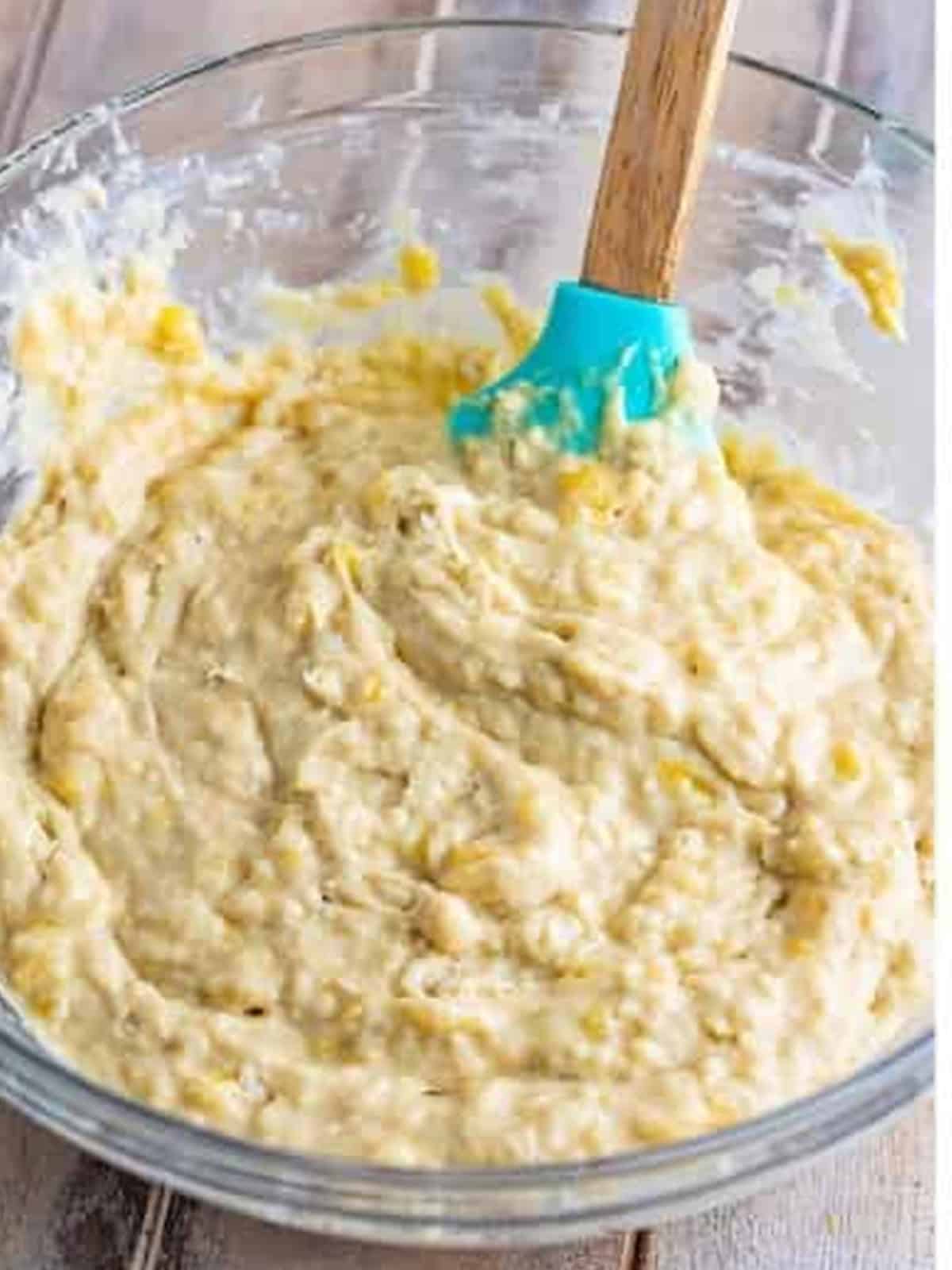 The mixed banana fritter batter in a glass bowl.