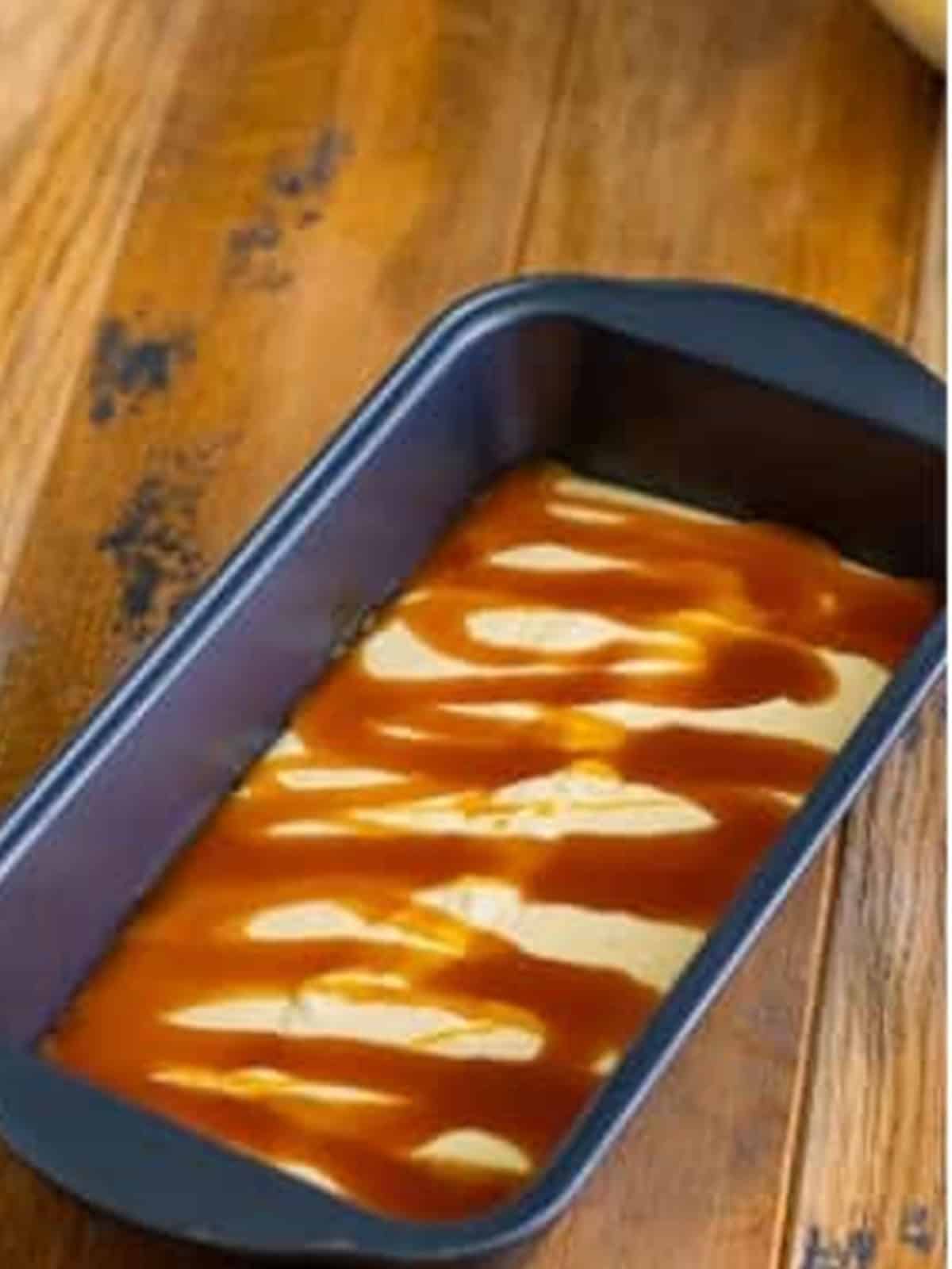 Butterscotch syrup drizzled over the first layer of ice cream.