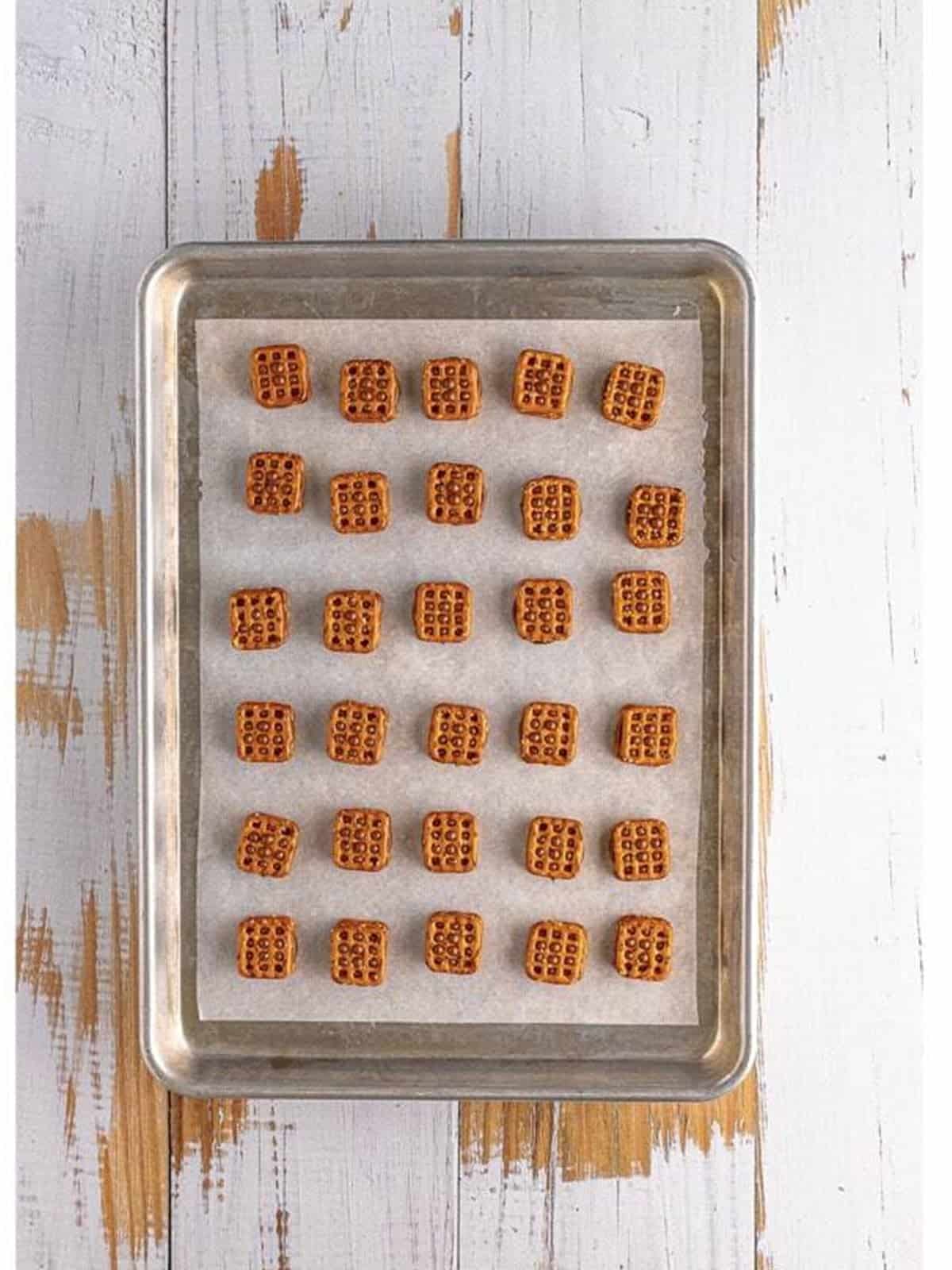 Finished rolo pretzels cooling on the baking sheet.