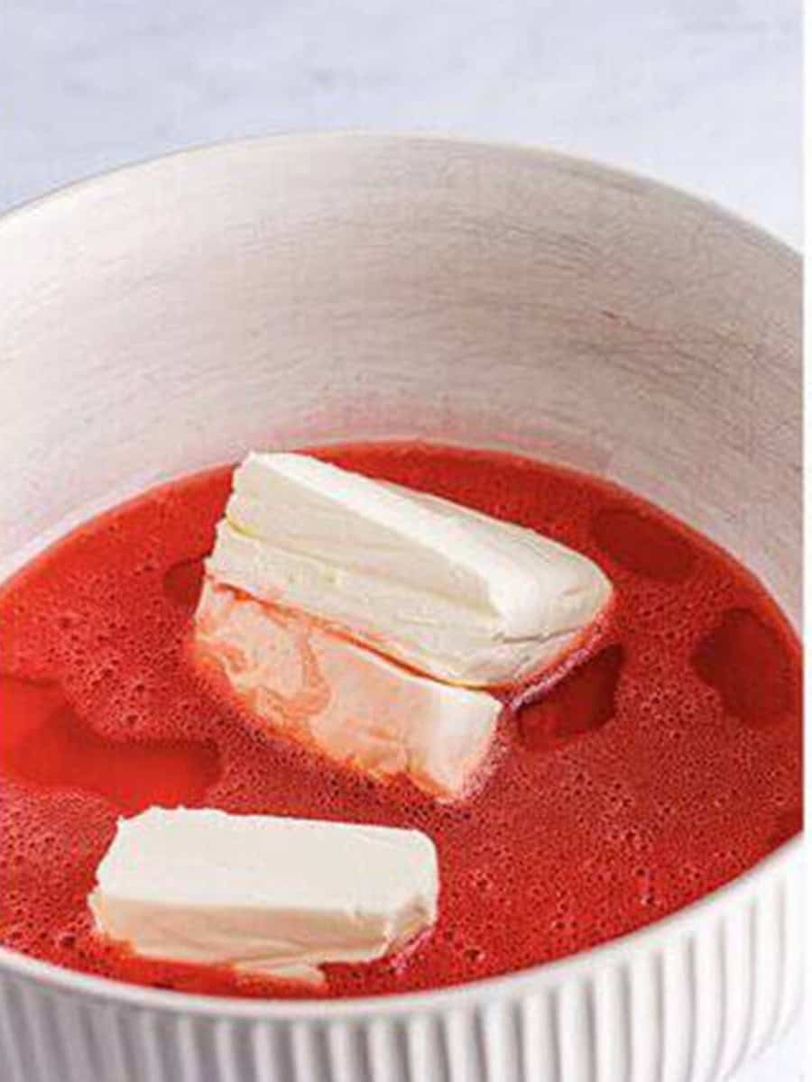 Cream cheese added to the dissolved strawberry banana jello.