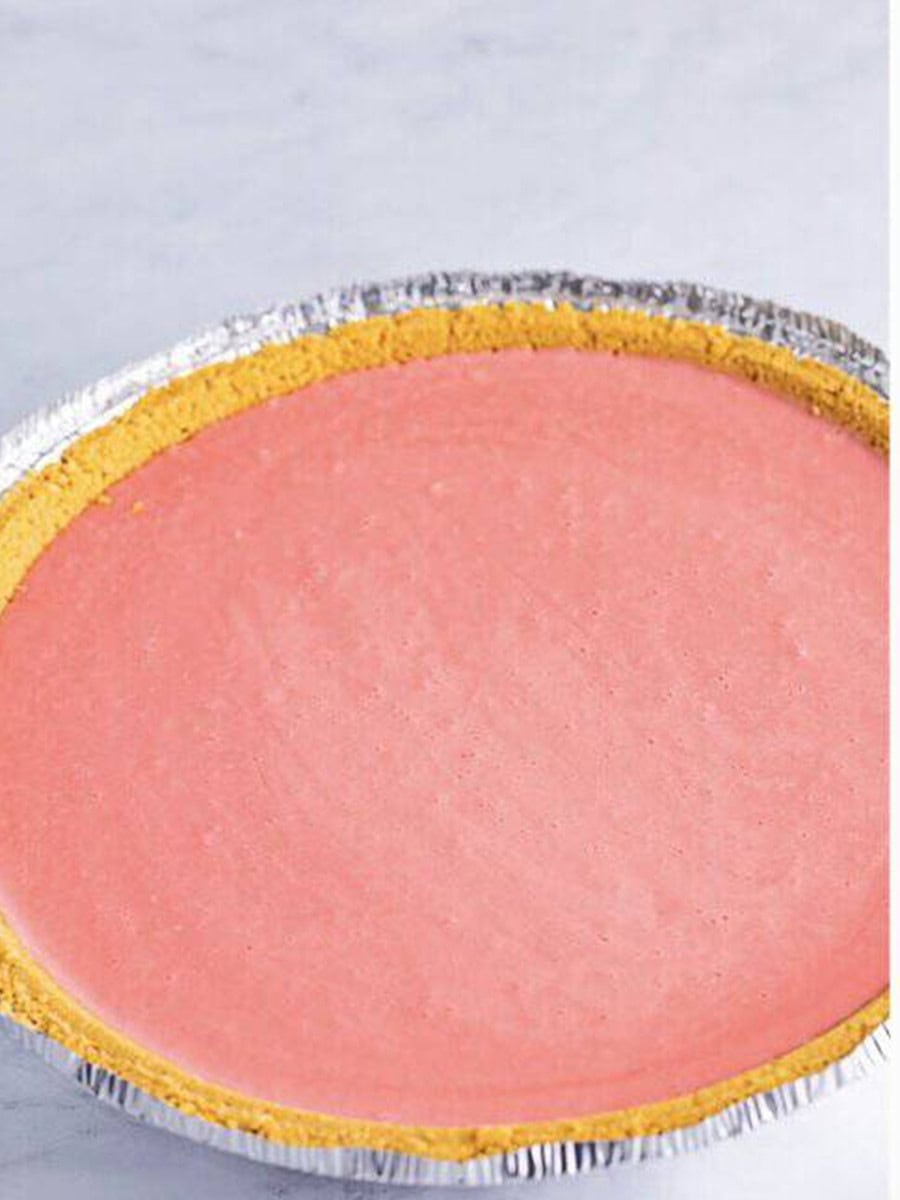 Strawberry banana jello filling poured into a graham cracker crust.