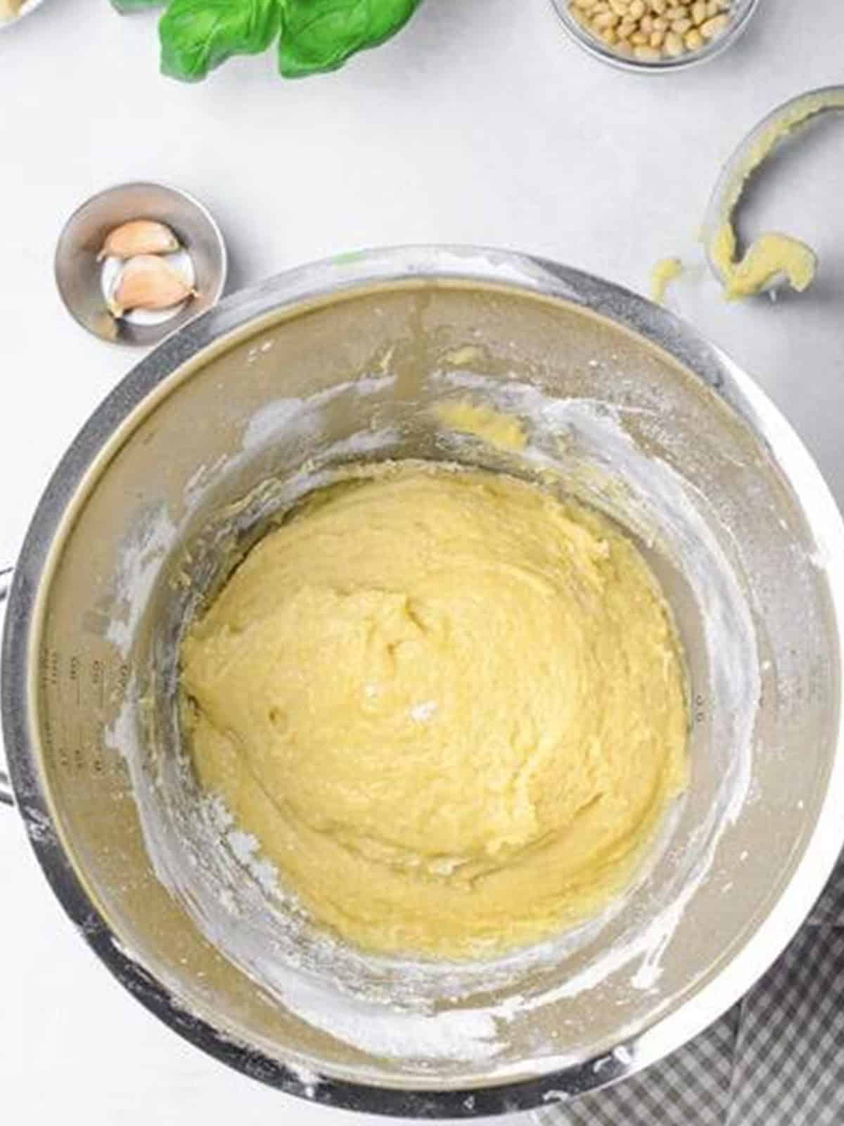 Smooth kneaded challah bread dough in a stand mixer bowl ready to rise.