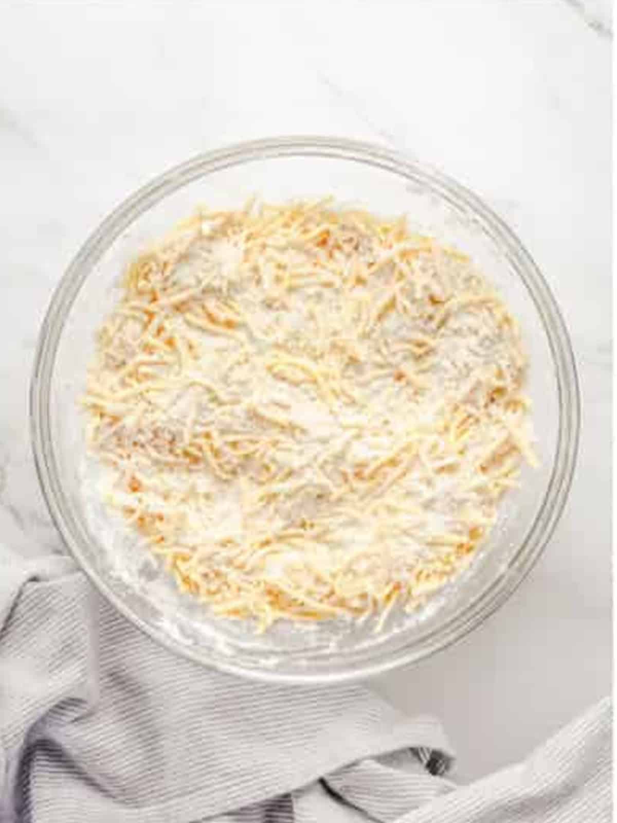 Shredded cheddar cheese stirred into the dry ingredients.