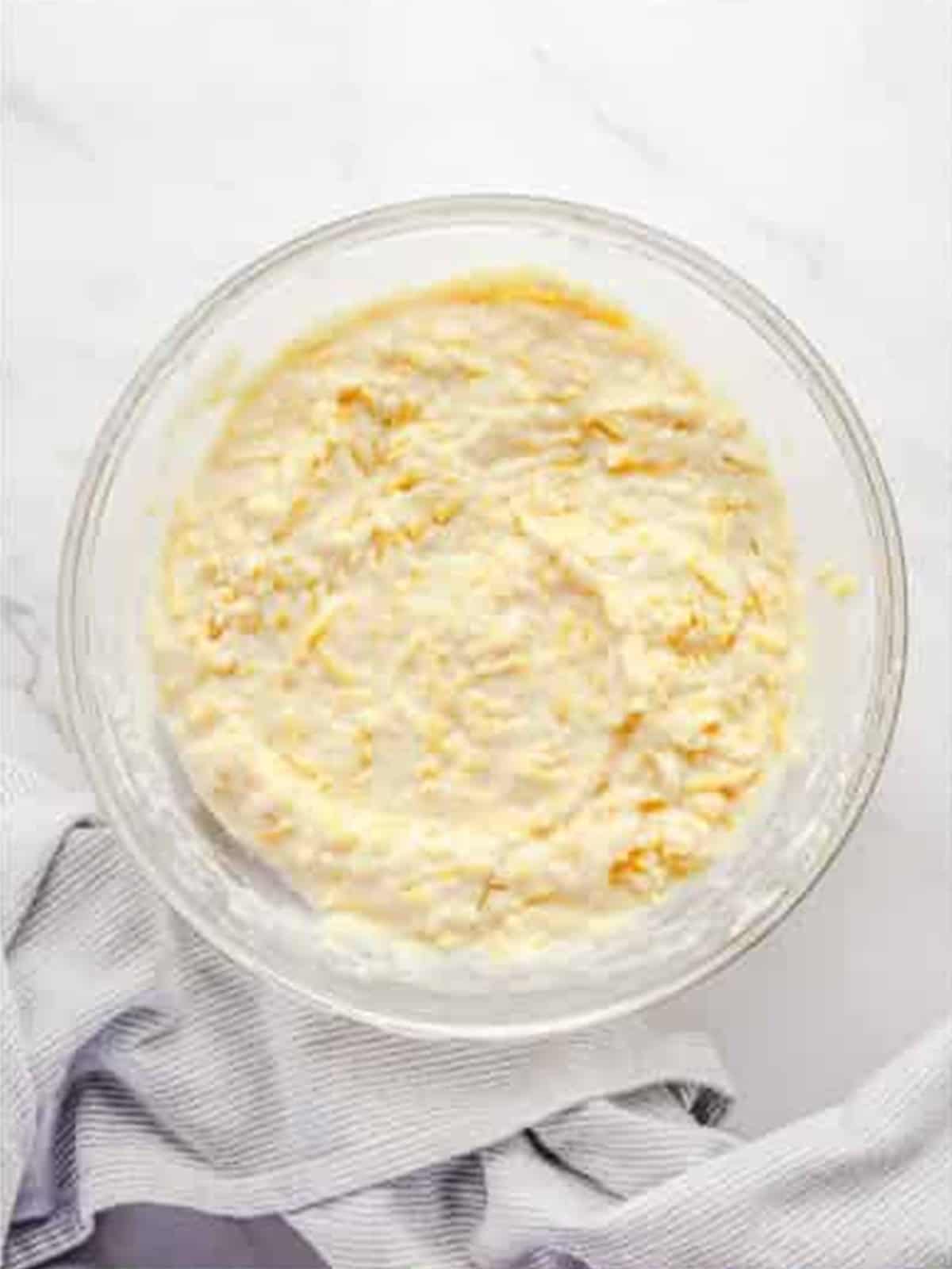 Wet ingredients stirred into the cheesy dry mixture to make the muffin batter.