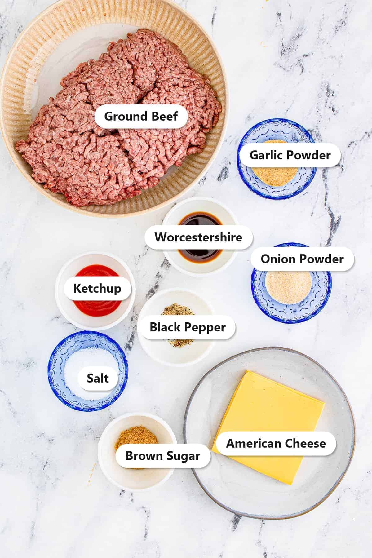 Labeled ingredients for cheeseburgers including ground beef, ketchup, Worcestershire sauce, brown sugar, garlic powder, onion powder, salt, pepper, and American cheese.