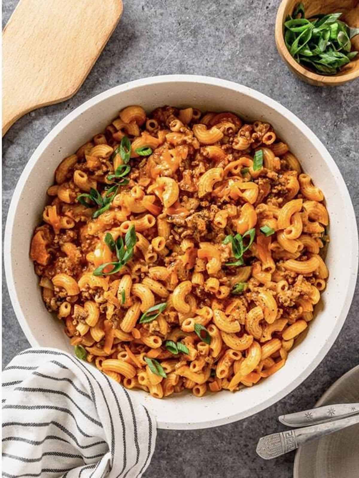 Finished Cheeseburger Pasta in a pan garnished with green onions.