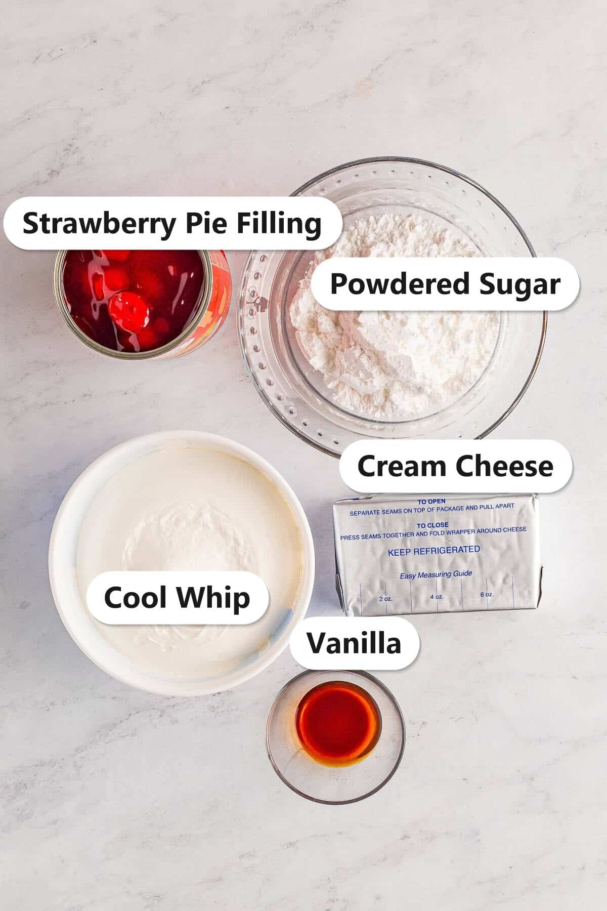 Labeled ingredients for cheesecake dip including cream cheese, cool whip, powdered sugar, vanilla, and strawberry pie filling.