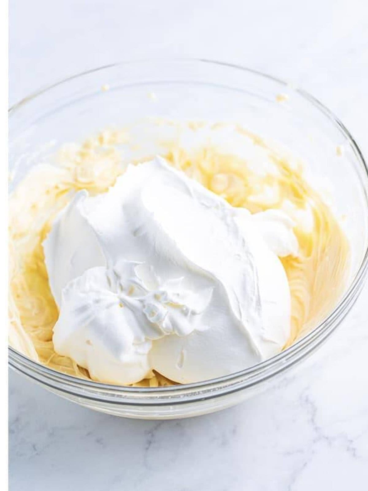 Cool whip folded into the whipped cream cheese mixture until no streaks remain.