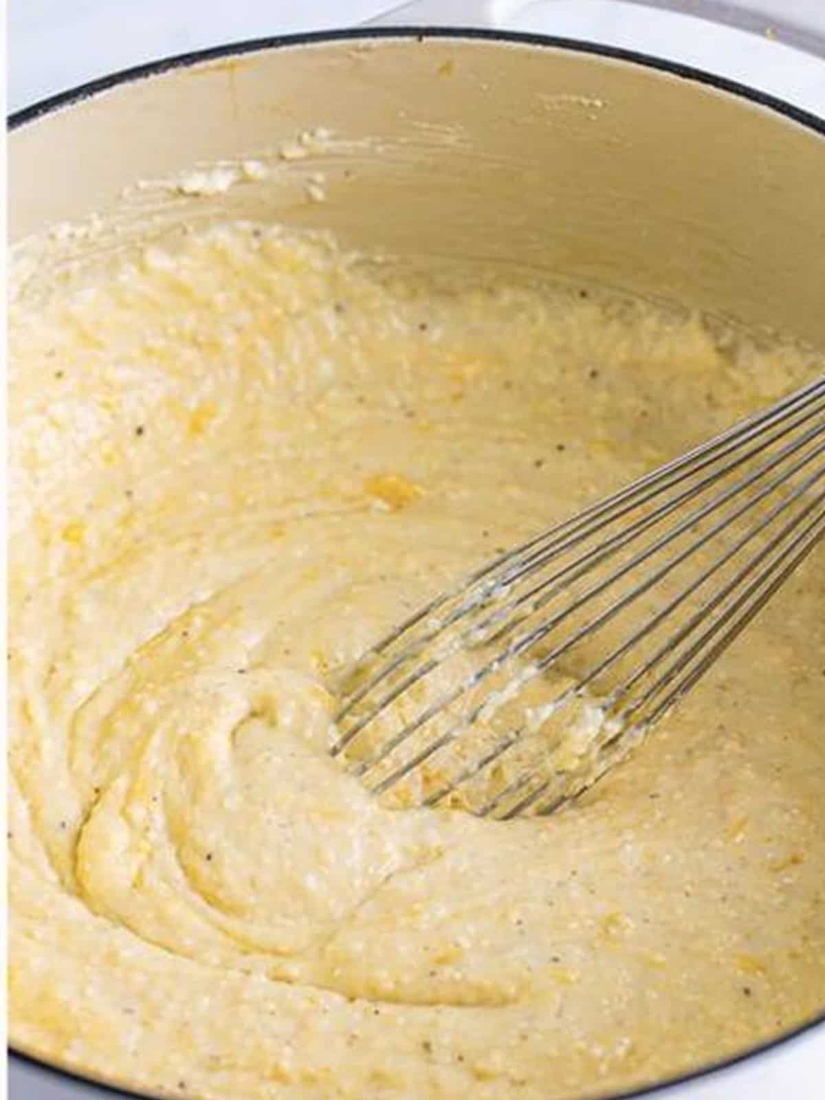 Cheesy grits whisked smooth after the butter and cheese melt in.