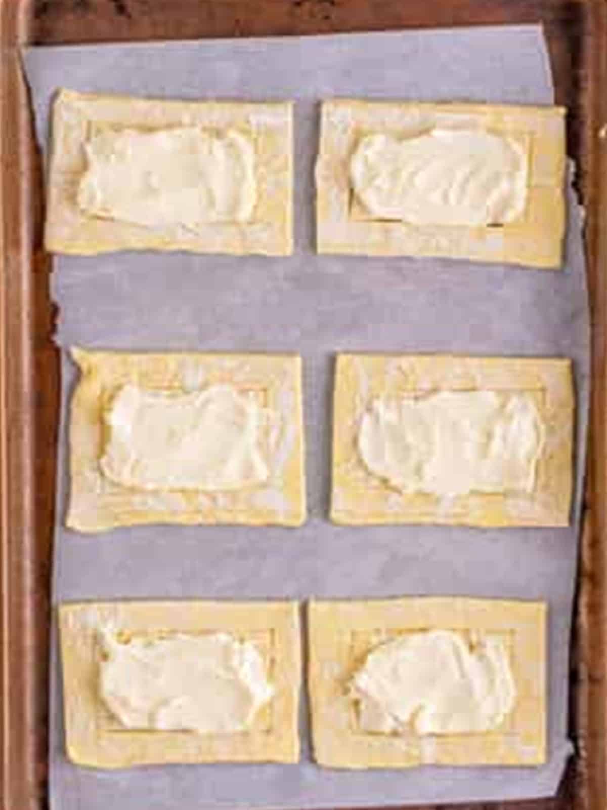 Cream cheese filling spread in the center of each pastry for Cherry Danish.