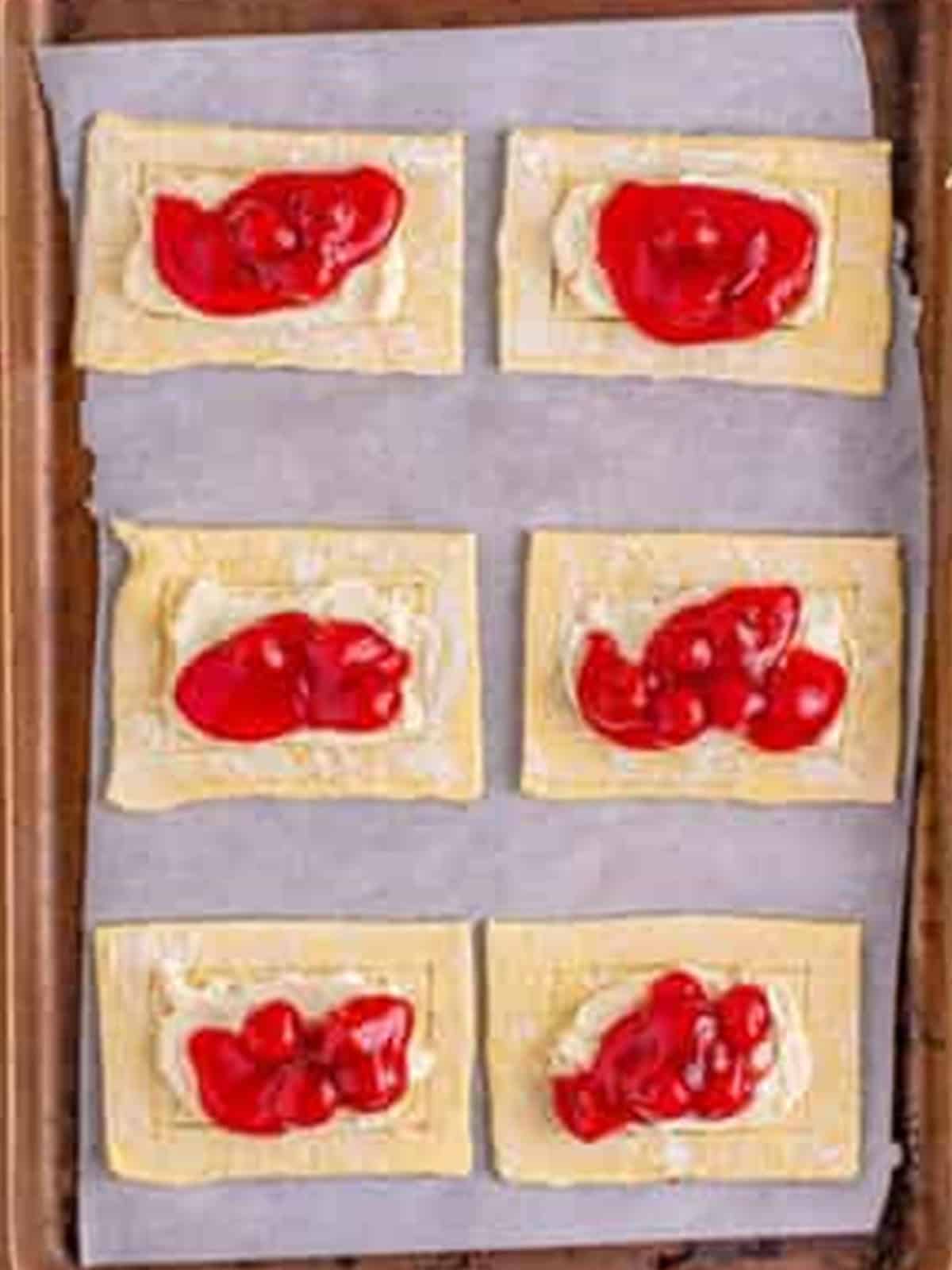 Cherry pie filling spooned over the cream cheese on each Cherry Danish.