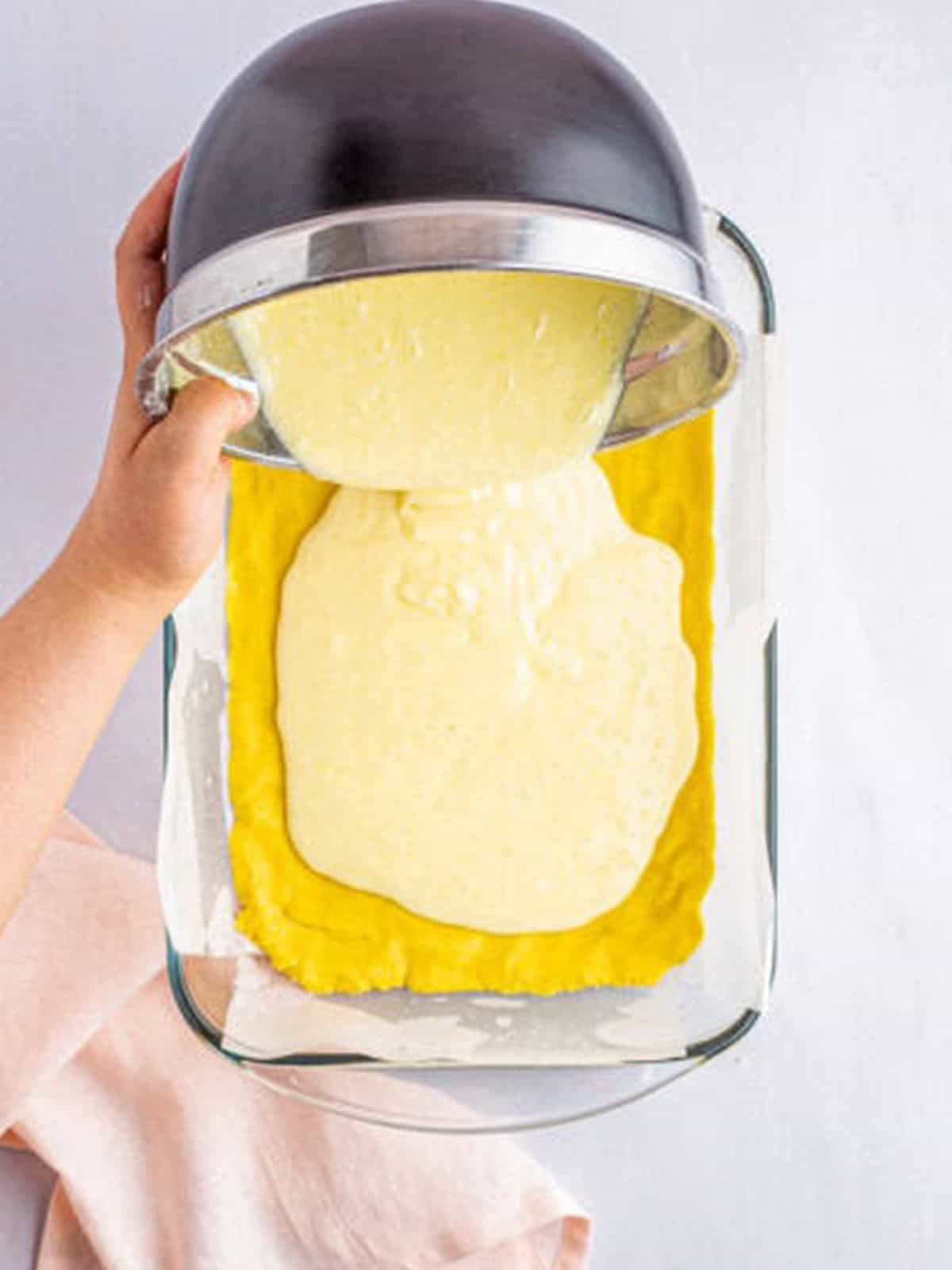 Gooey cream cheese filling poured over the cake mix crust in the pan.