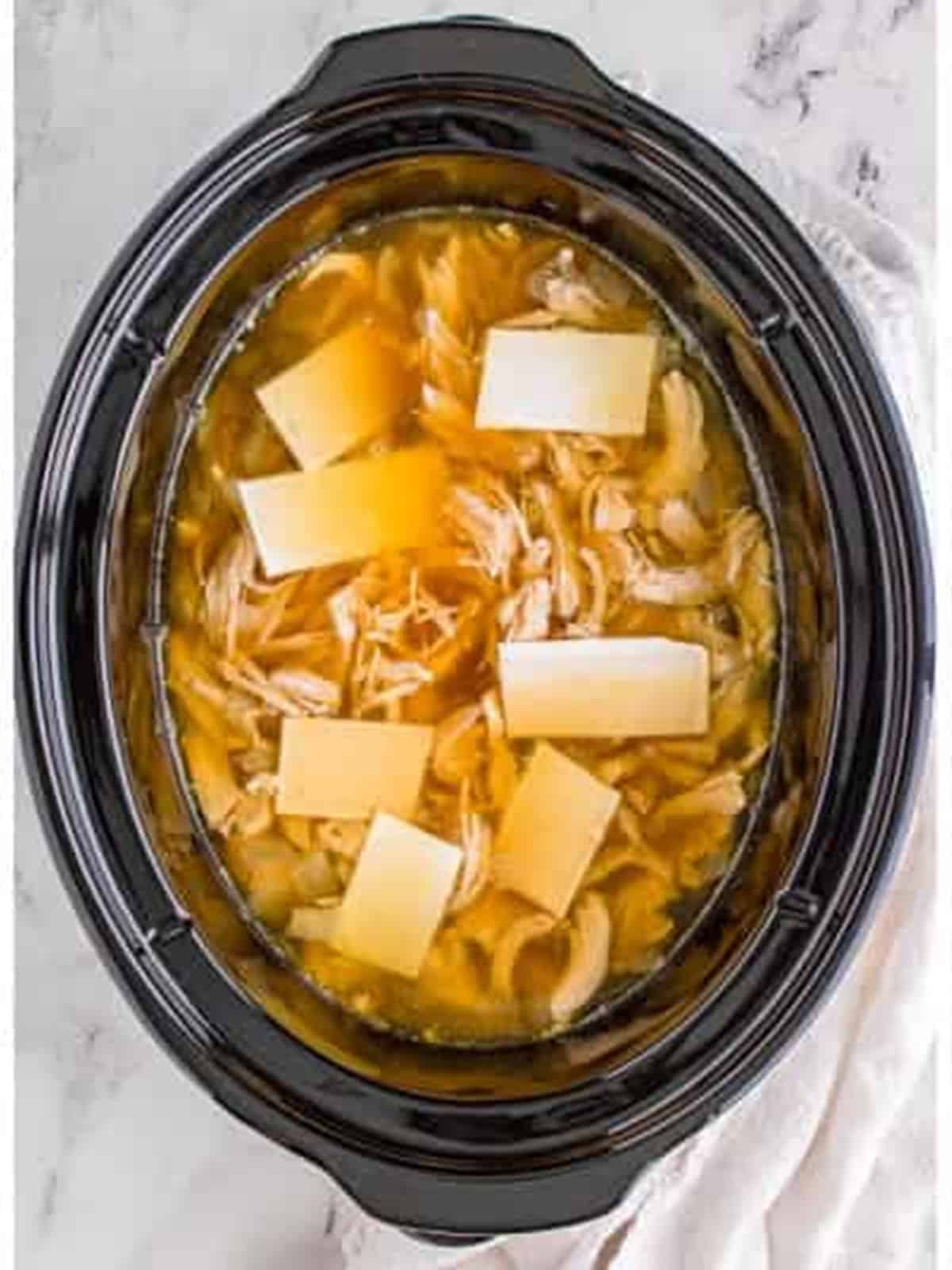 Torn frozen dumplings added to the slow cooker.