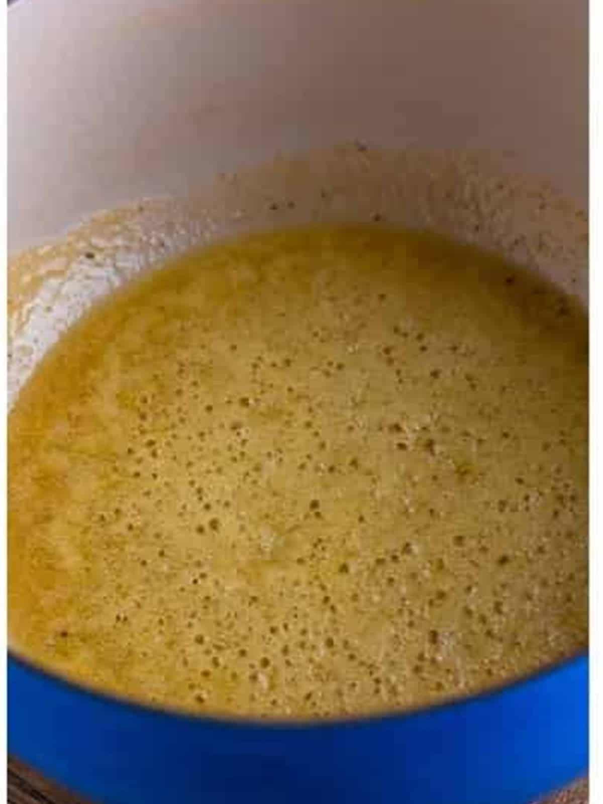Whisking butter and flour into a golden roux for the alfredo sauce.