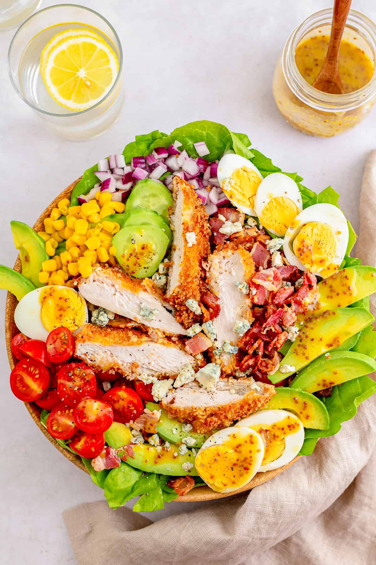 Crispy breaded chicken frying in a skillet for the Cobb Salad.