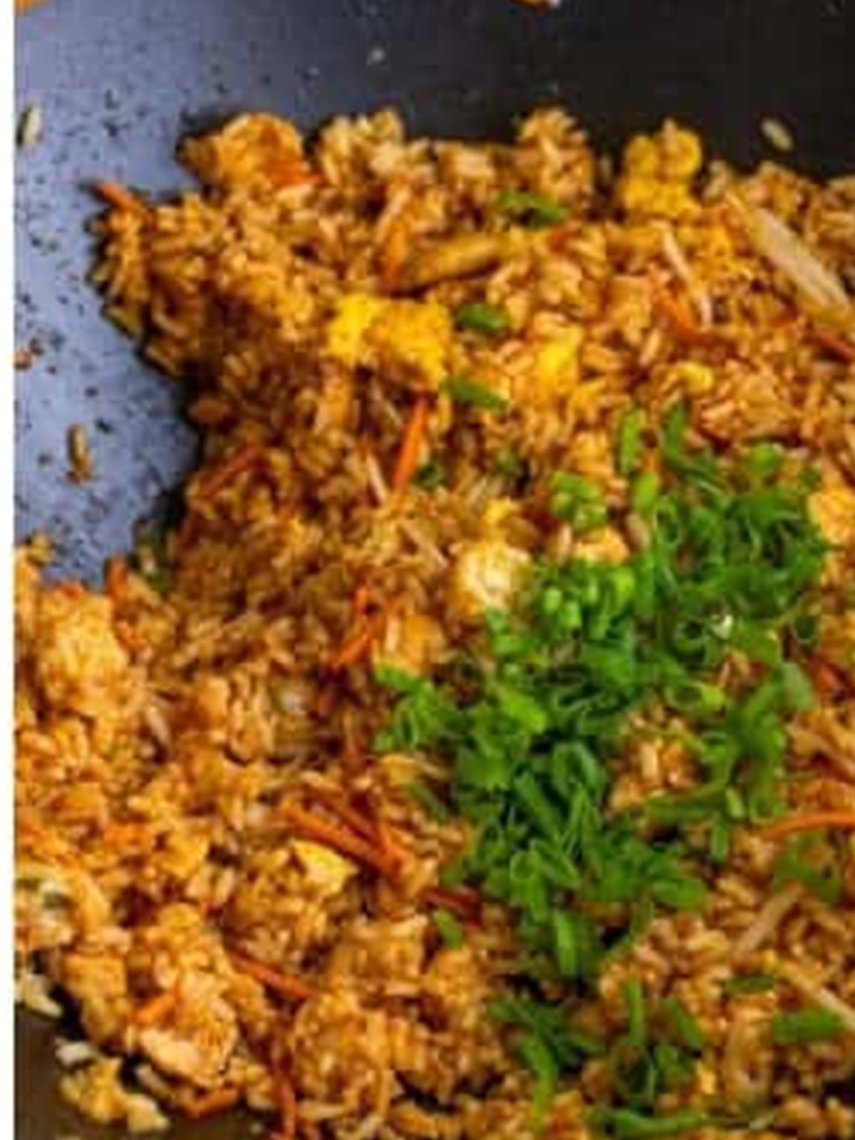Finished chicken fried rice topped with sliced green onions
