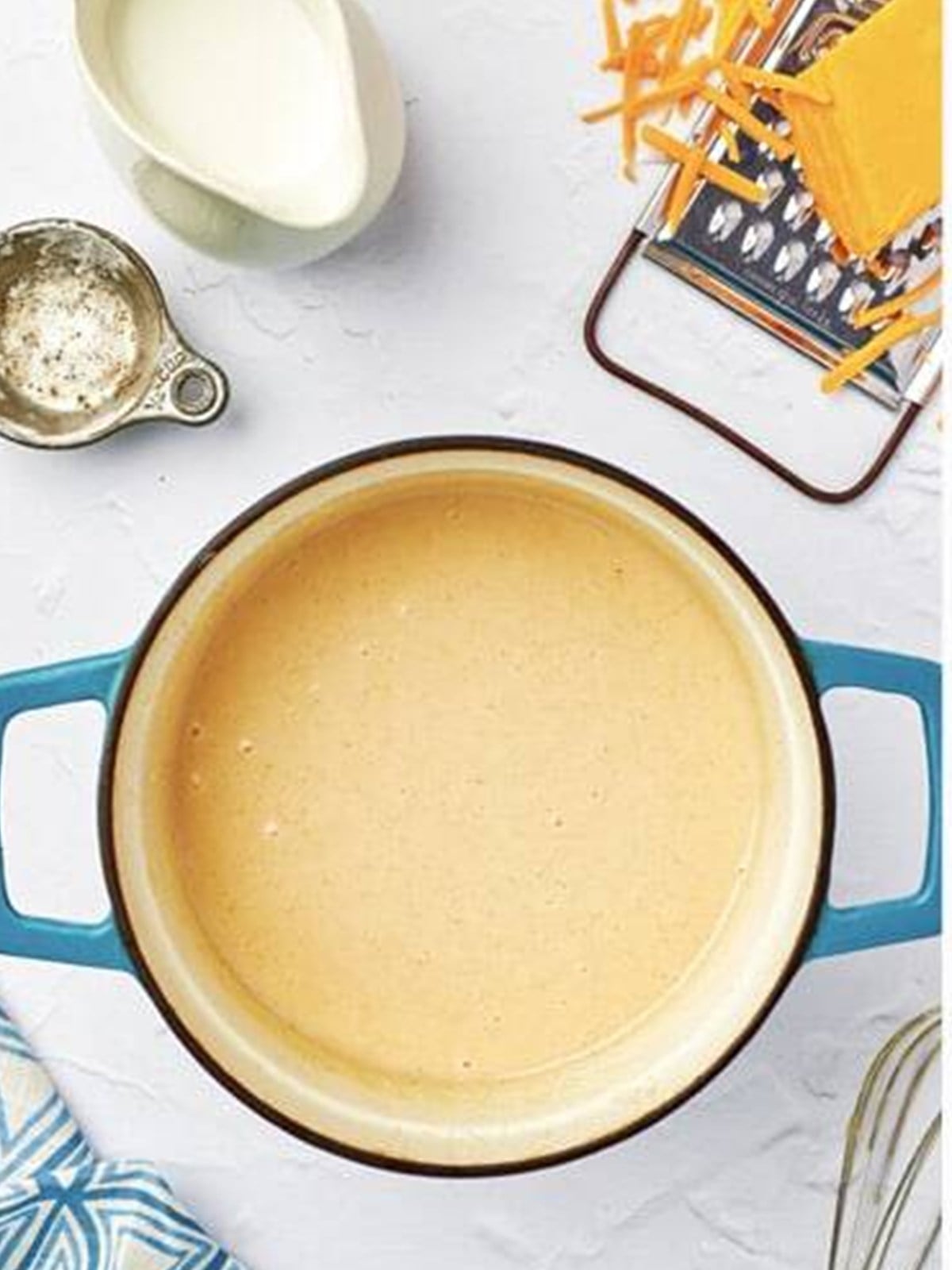 Milk whisked into the roux and simmered until smooth and thickened.
