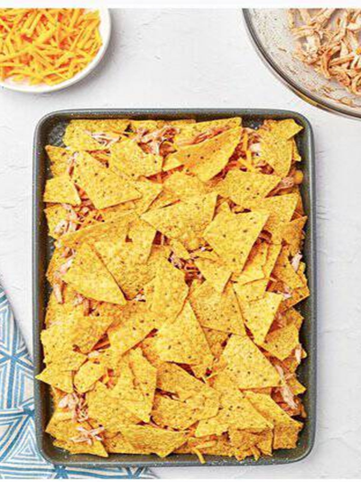 Chips layered with nacho cheese sauce, BBQ chicken, and shredded cheese.