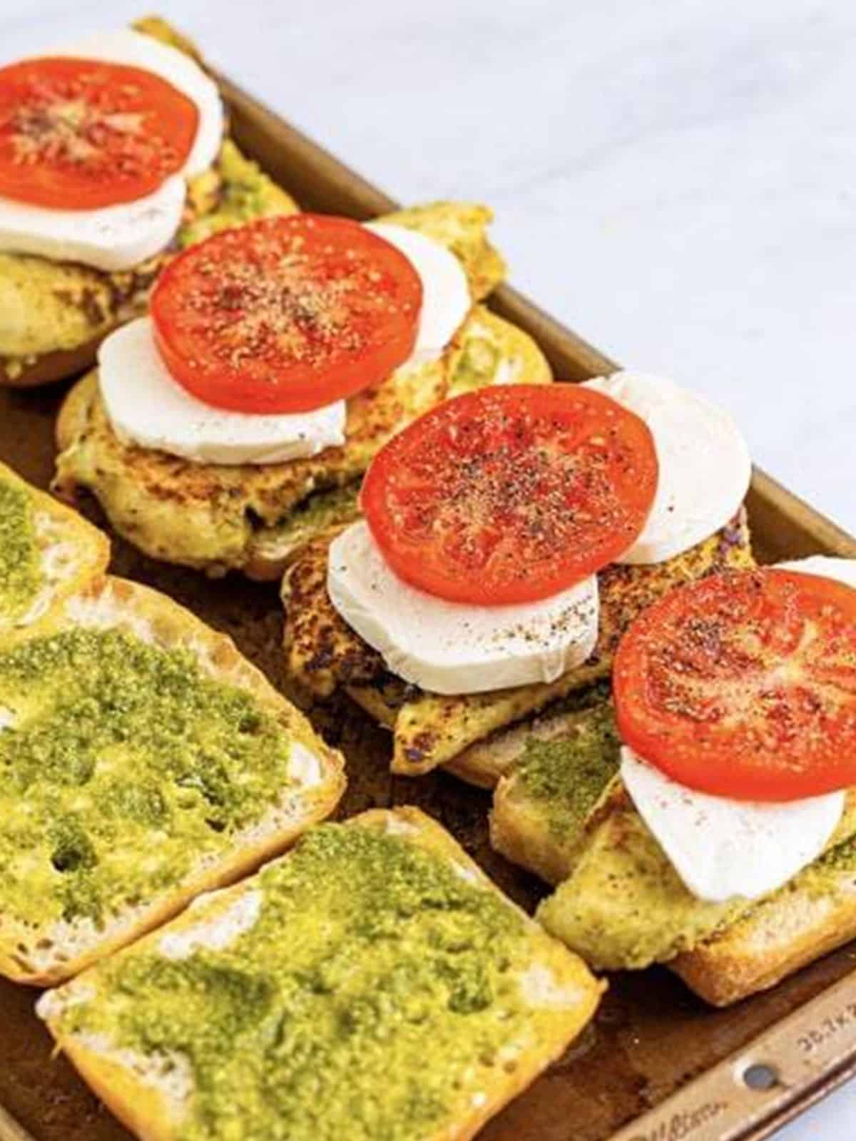 Sliced beefsteak tomato added to the open chicken pesto sandwiches.