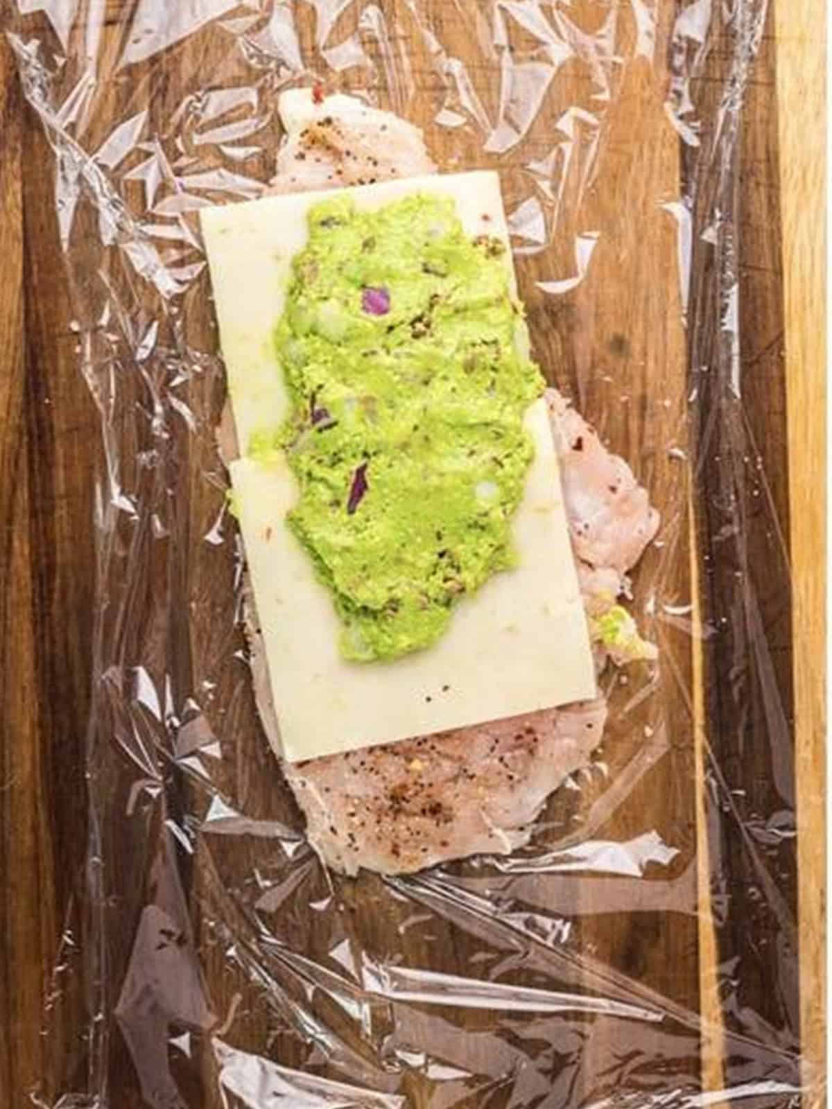 Pepper jack cheese and avocado bacon filling spread over a pounded chicken breast.