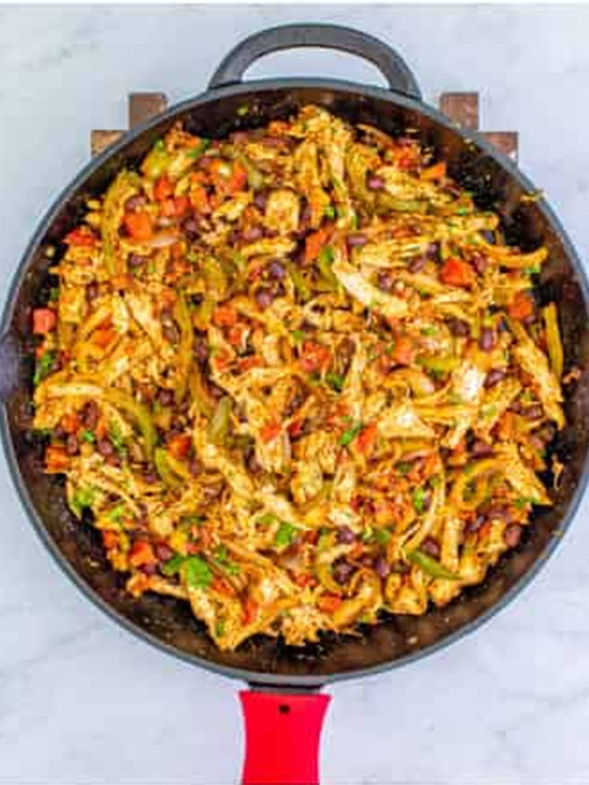 Cooked chicken quesadilla filling in a skillet.