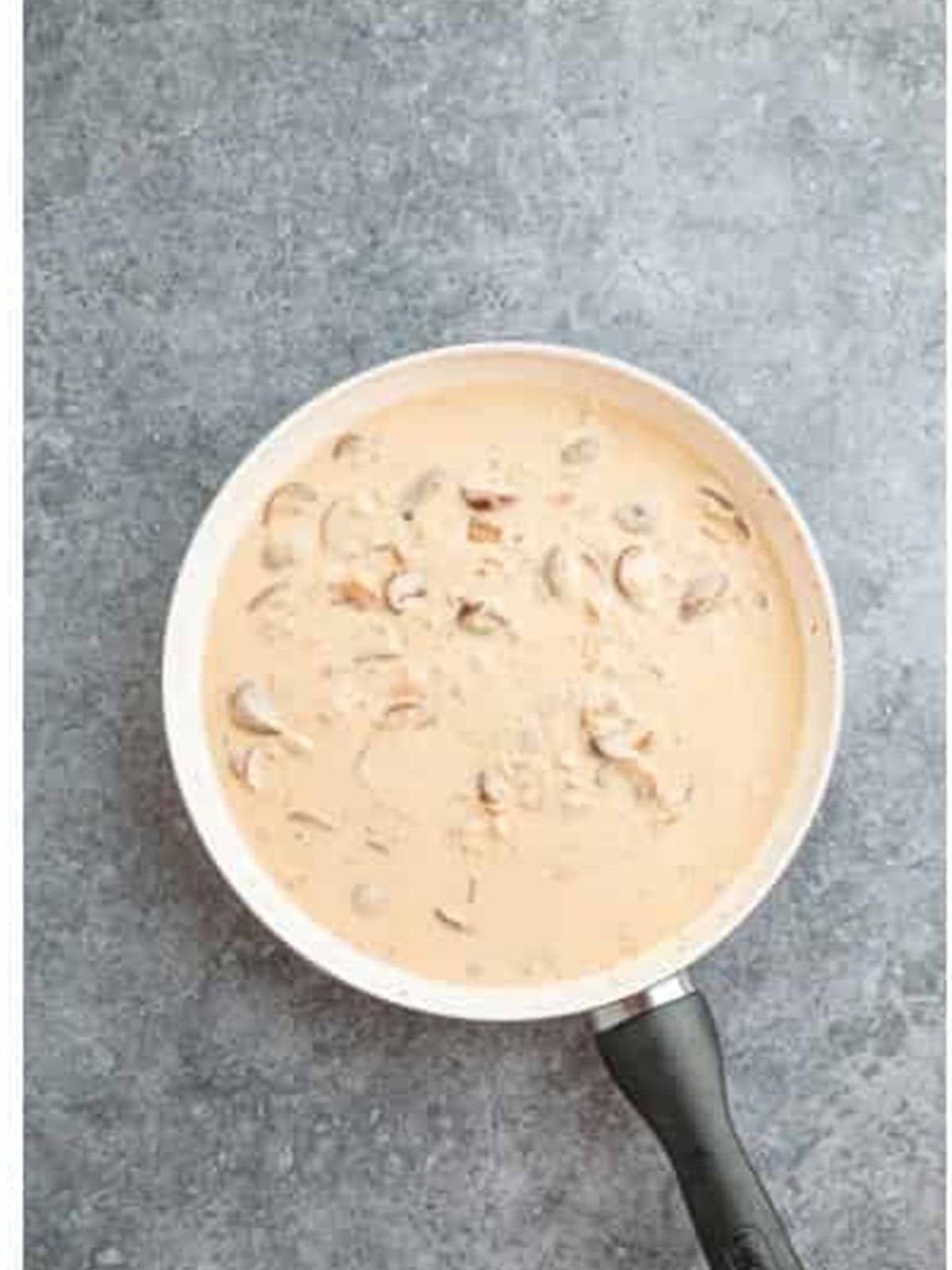 Creamy mushroom stroganoff sauce simmering in the skillet.
