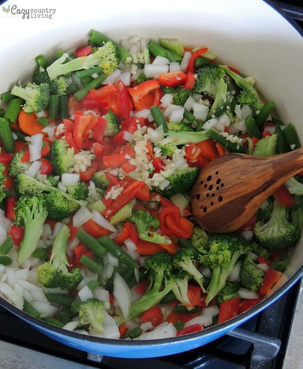 Chopped vegetables sauteing in a pot for chicken vegetable soup.