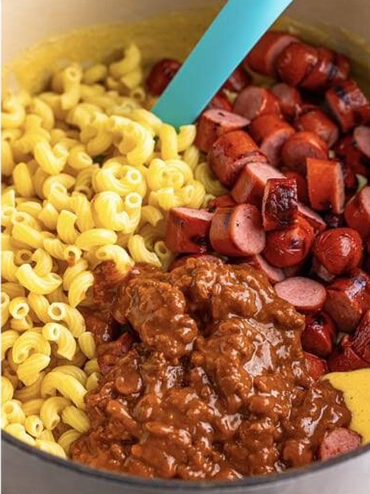 Cooked macaroni, sliced hot dogs, and chili stirred into the cheese sauce.