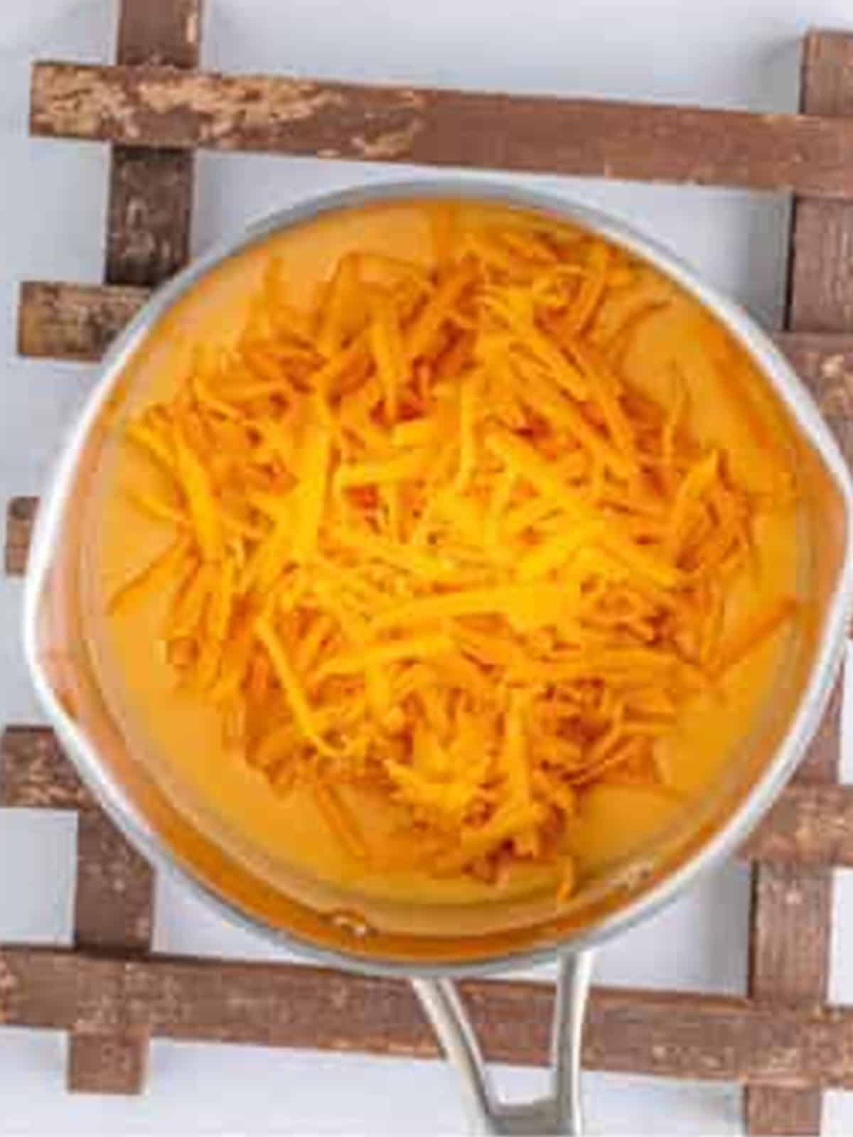 Shredded cheddar cheese melted into the cheese sauce.