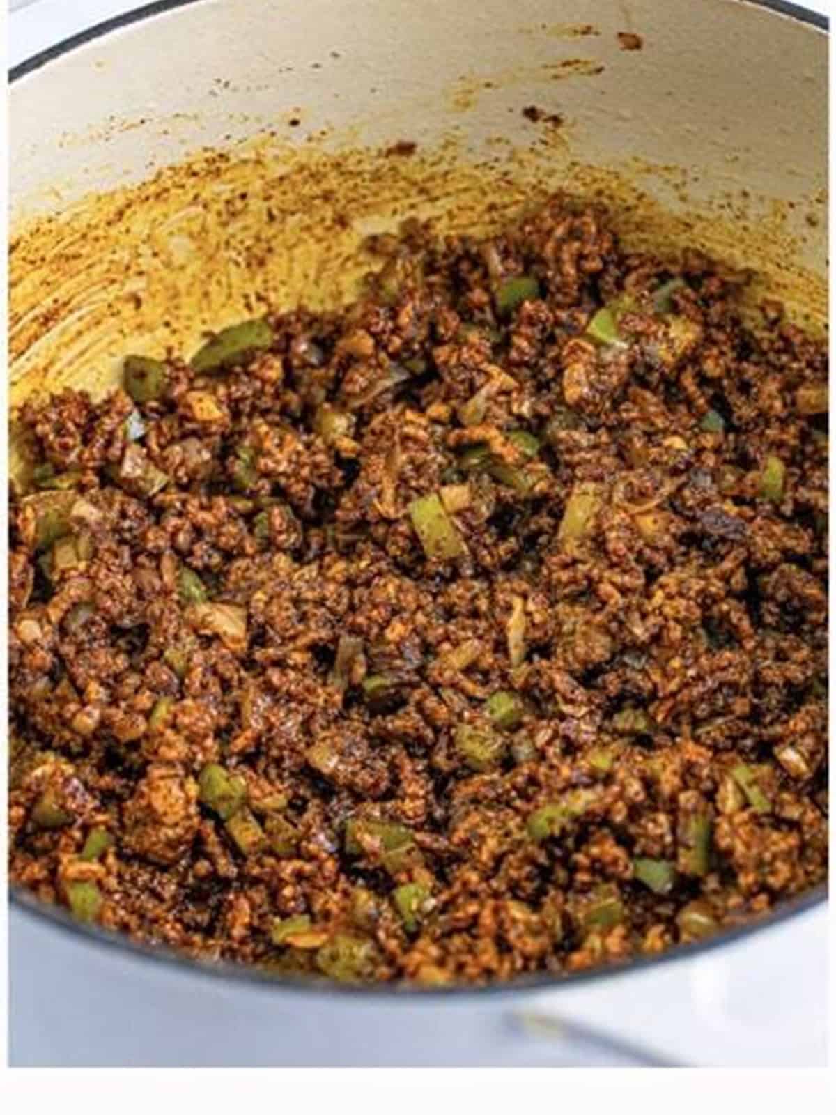 Chili seasoning and spices stirred into browned beef for chili mac.