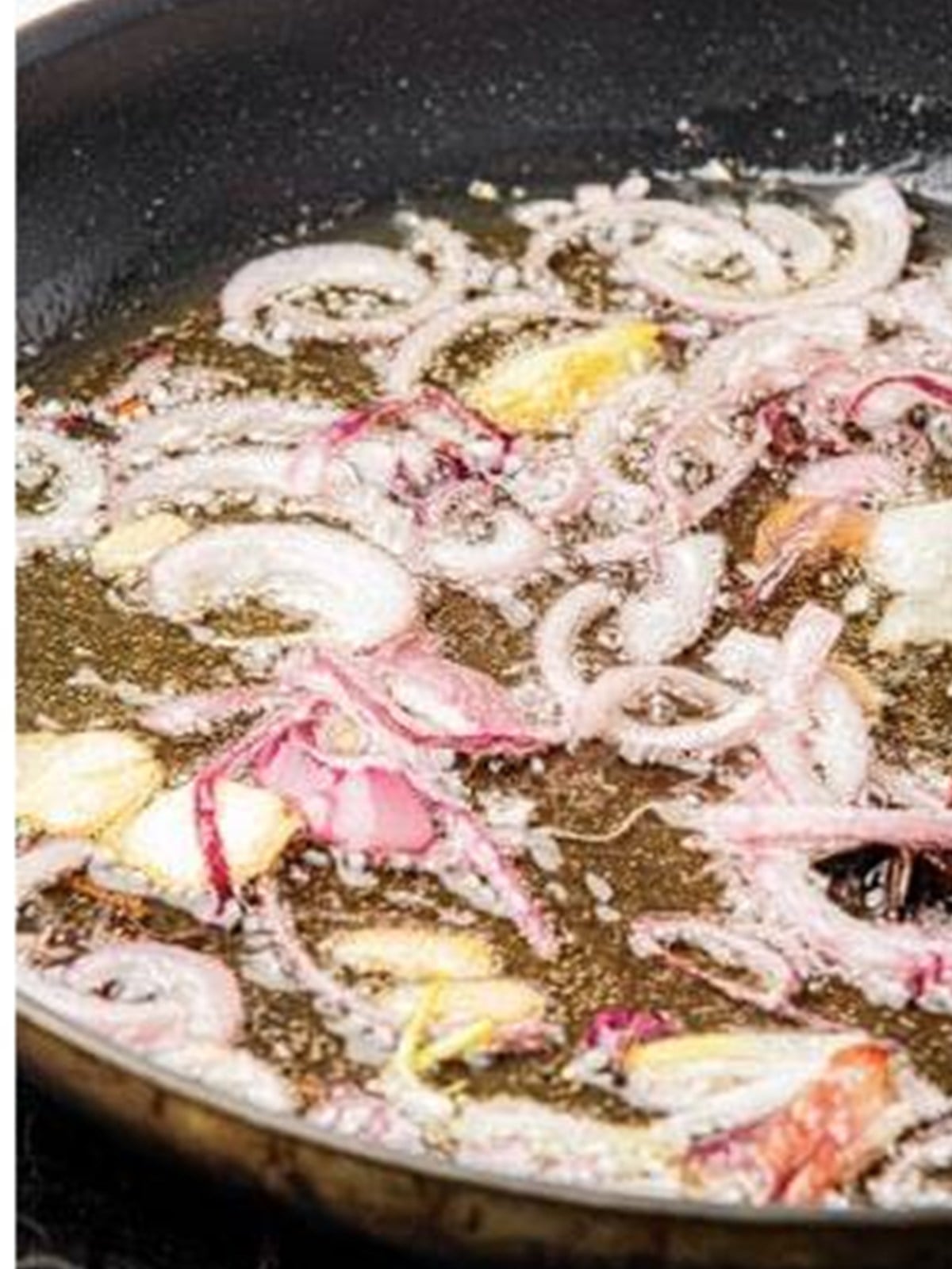 Aromatics and star anise frying until browned in oil for chili oil.