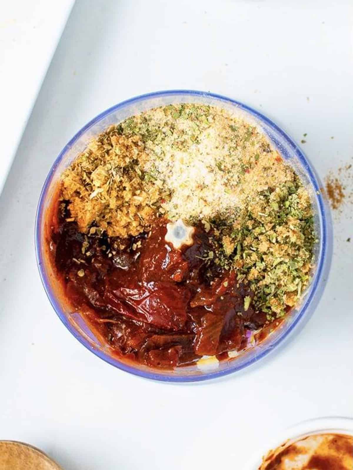 Chipotle peppers, spices, and brown sugar added to a blender to make chipotle chicken marinade.