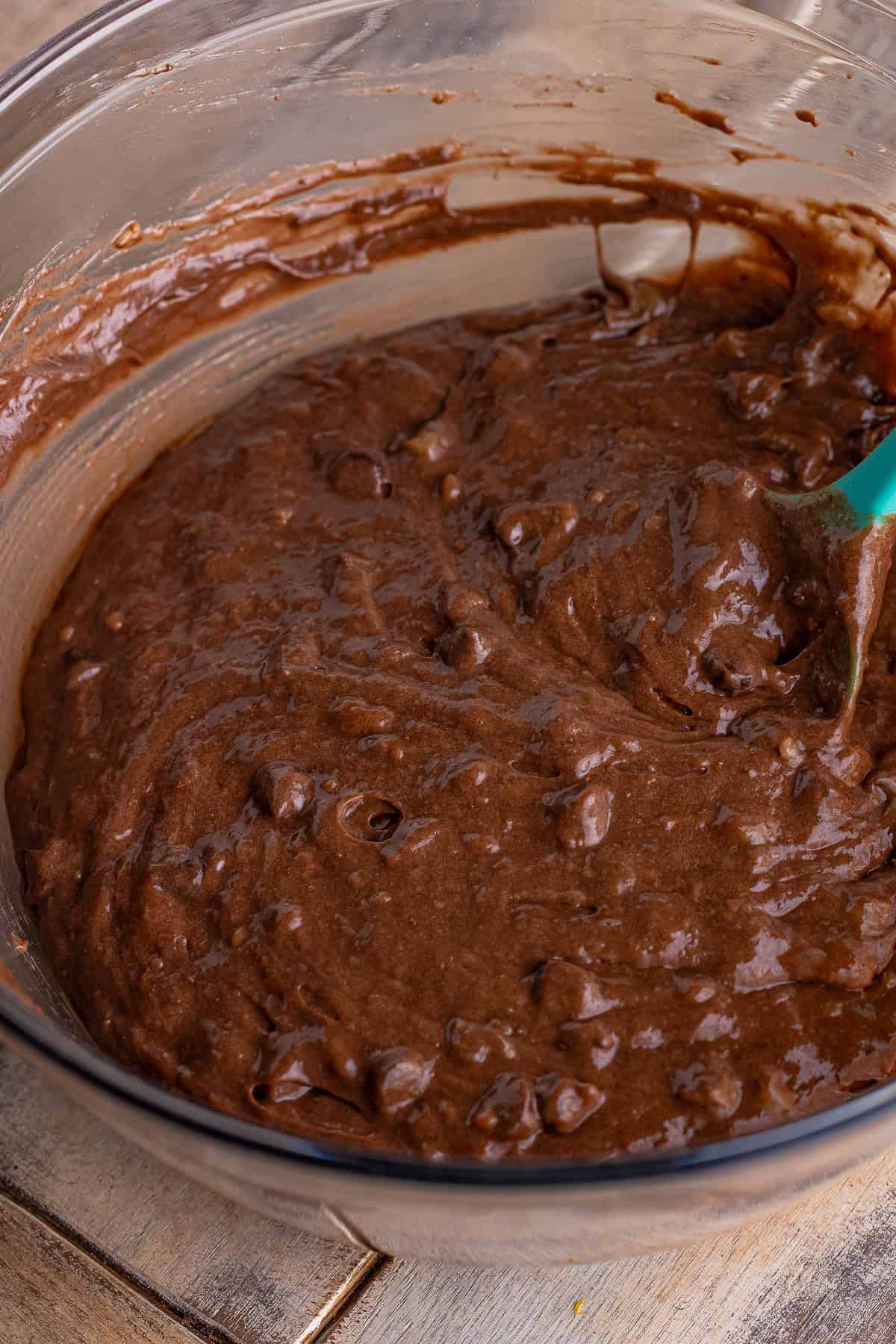 Folding semi sweet chocolate chips into the chocolate banana muffin batter.