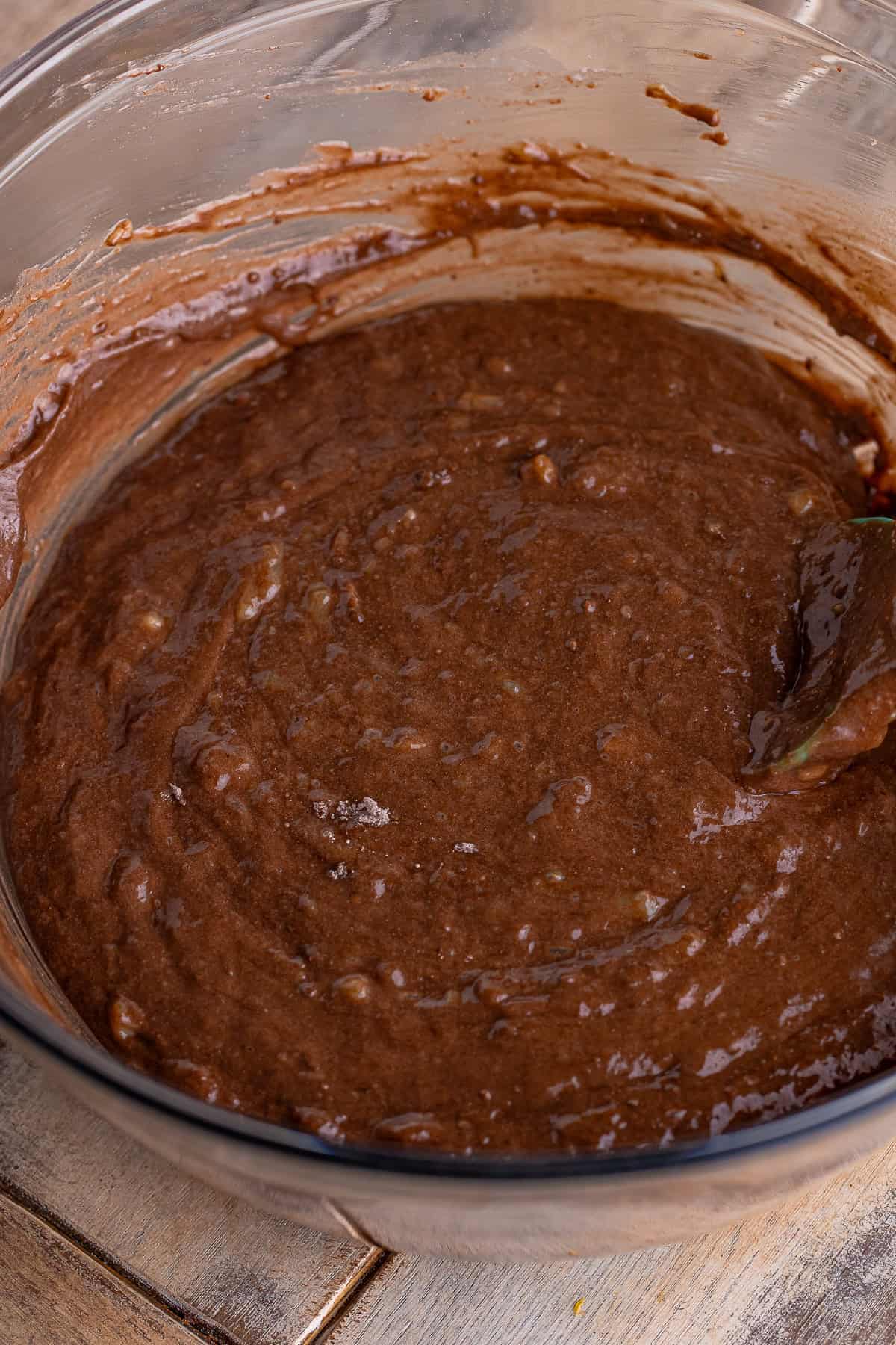 Smooth chocolate banana muffin batter mixed in a bowl.